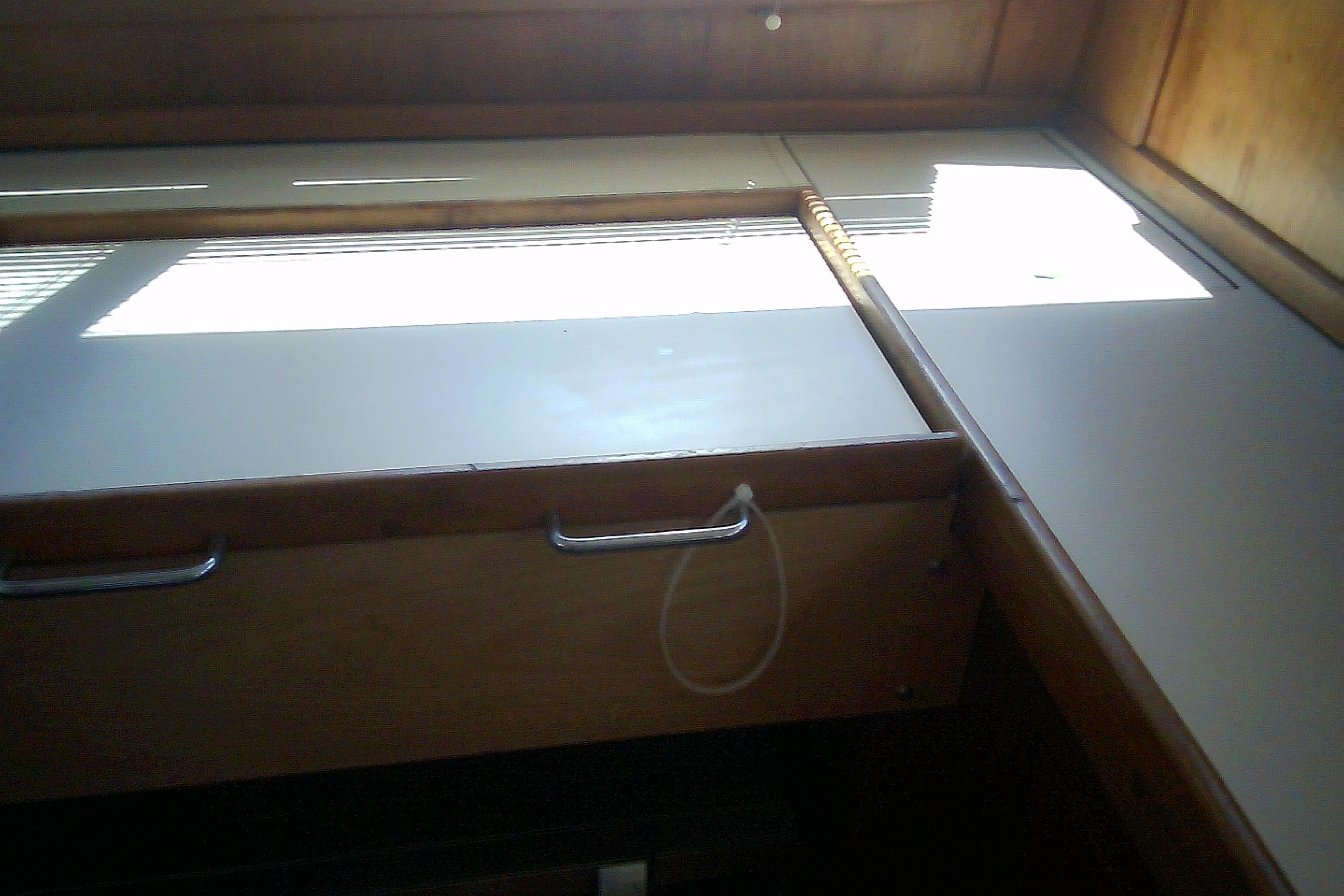 Interior view of a 1999 Sabre 34 sailboat, featuring wooden cabinetry and natural light.