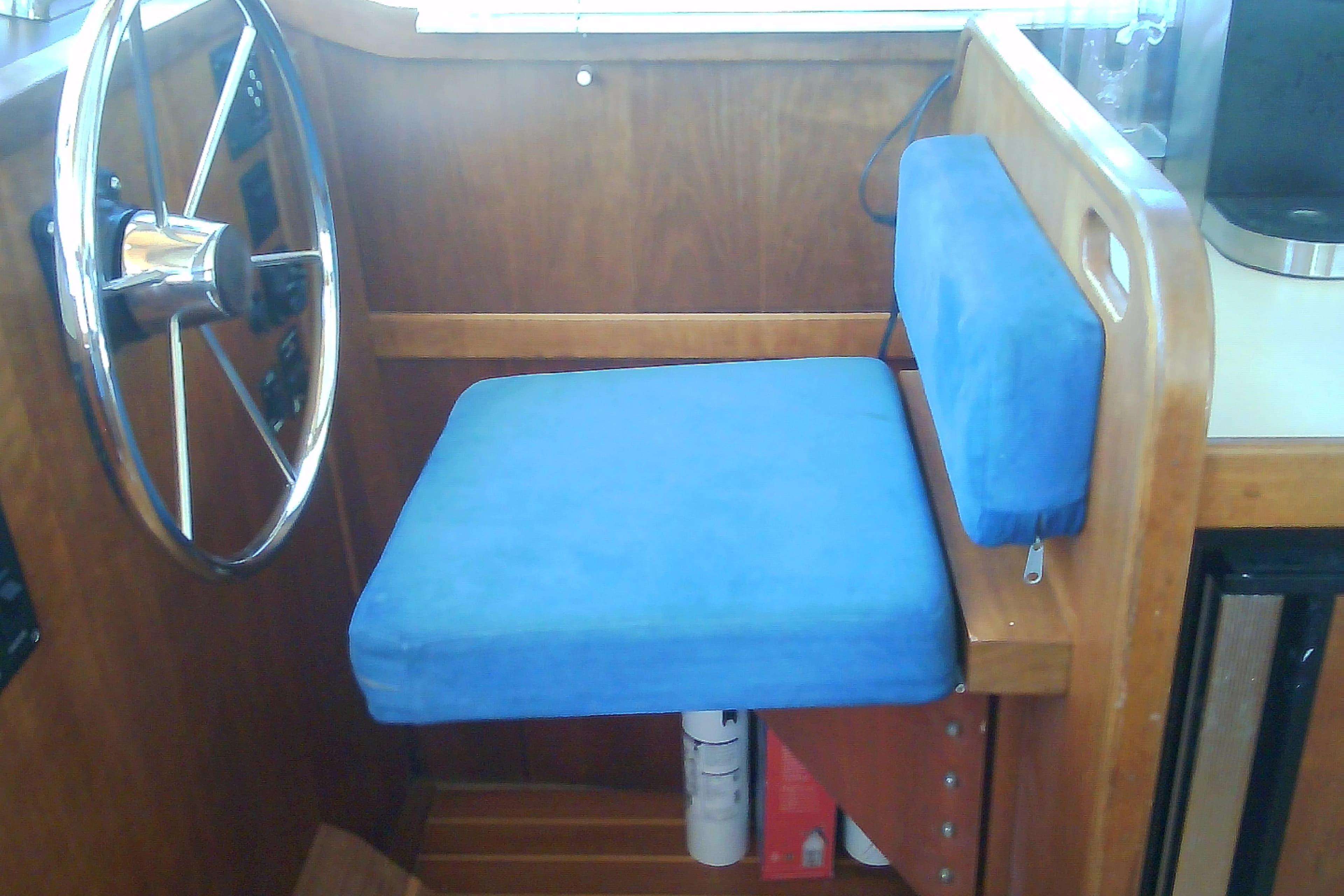 Blue cushioned helm seat in 1999 Sabre 34 boat interior.