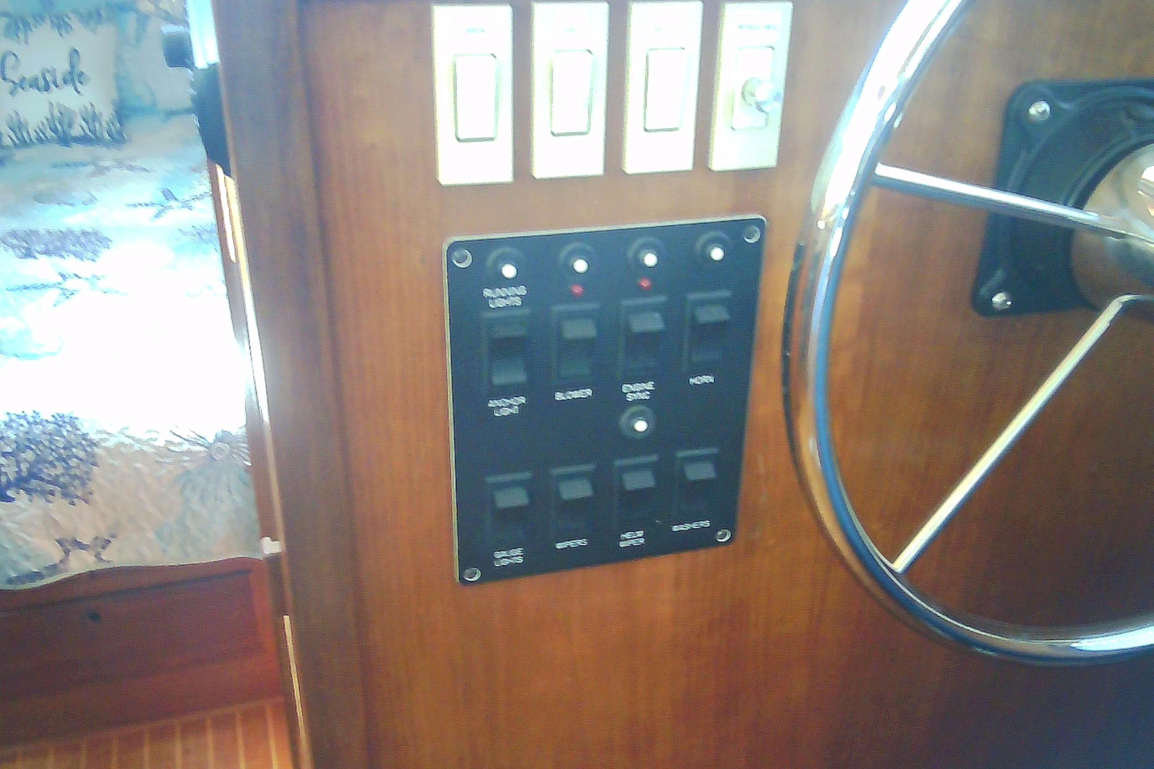 Control panel and steering wheel of a 1999 Sabre 34 boat interior.