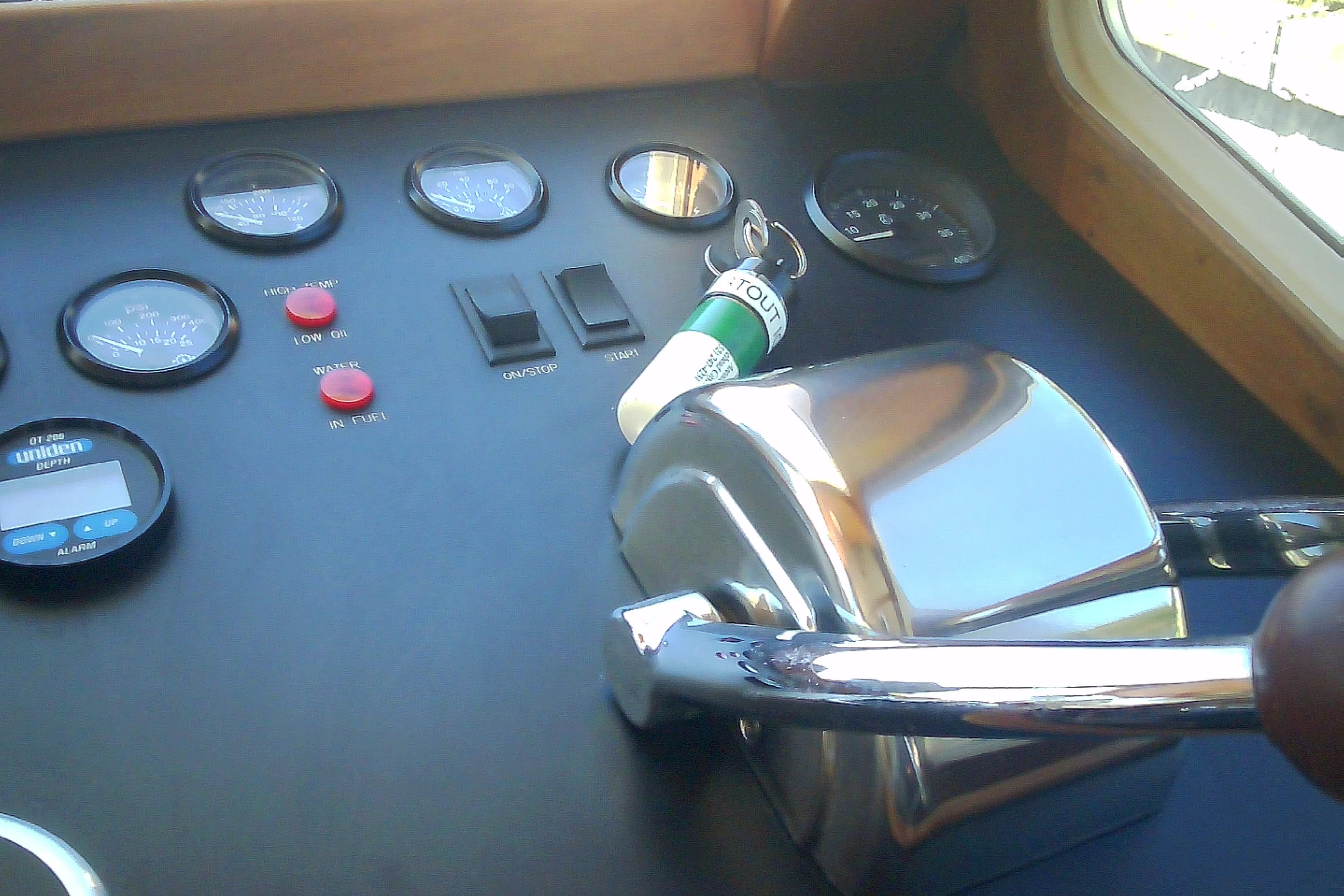 1999 Sabre 34 boat dashboard with gauges, switches, and throttle controls.