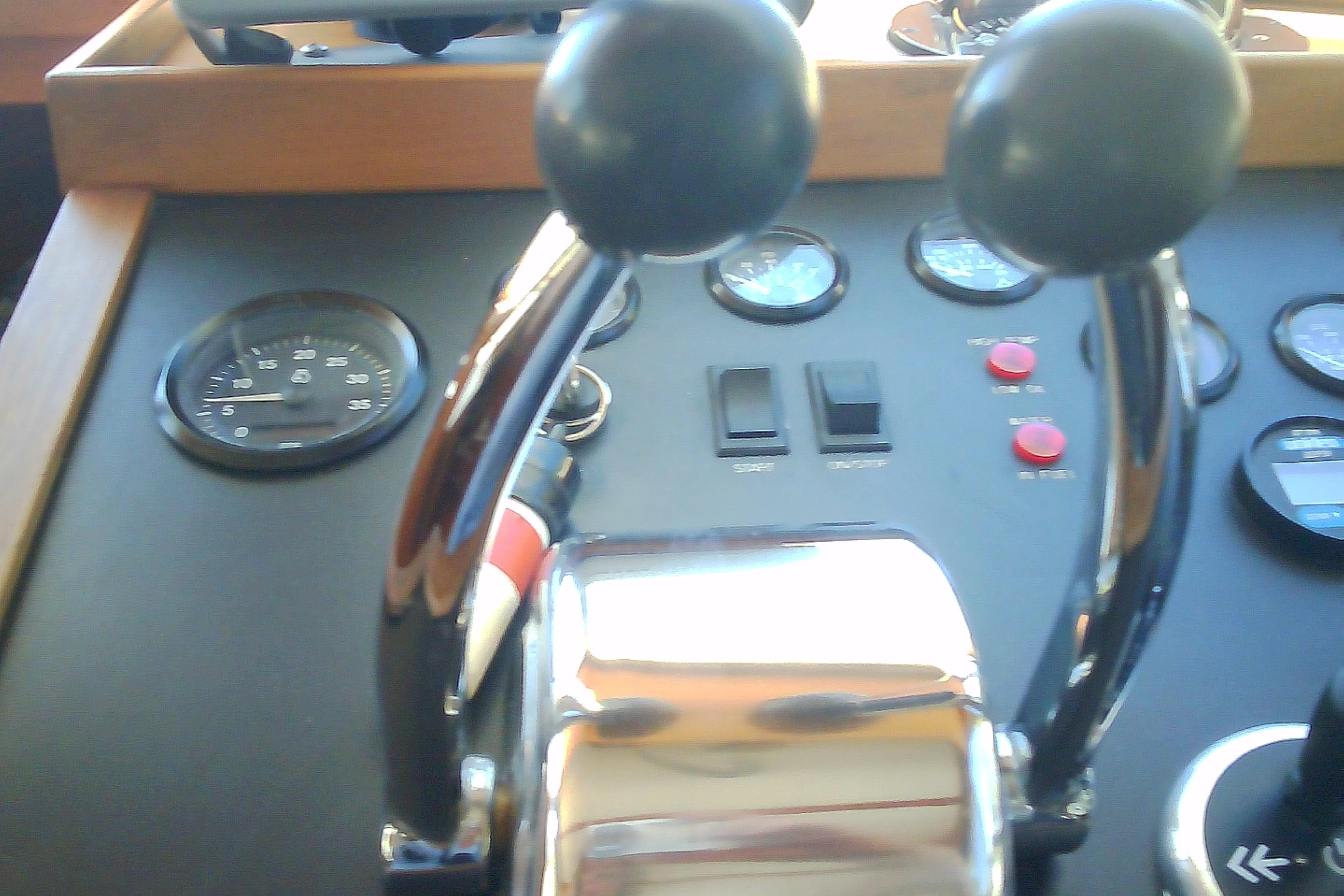 Boat control panel with dual throttle levers, gauges, and switches, Sabre 34, 1999 model.