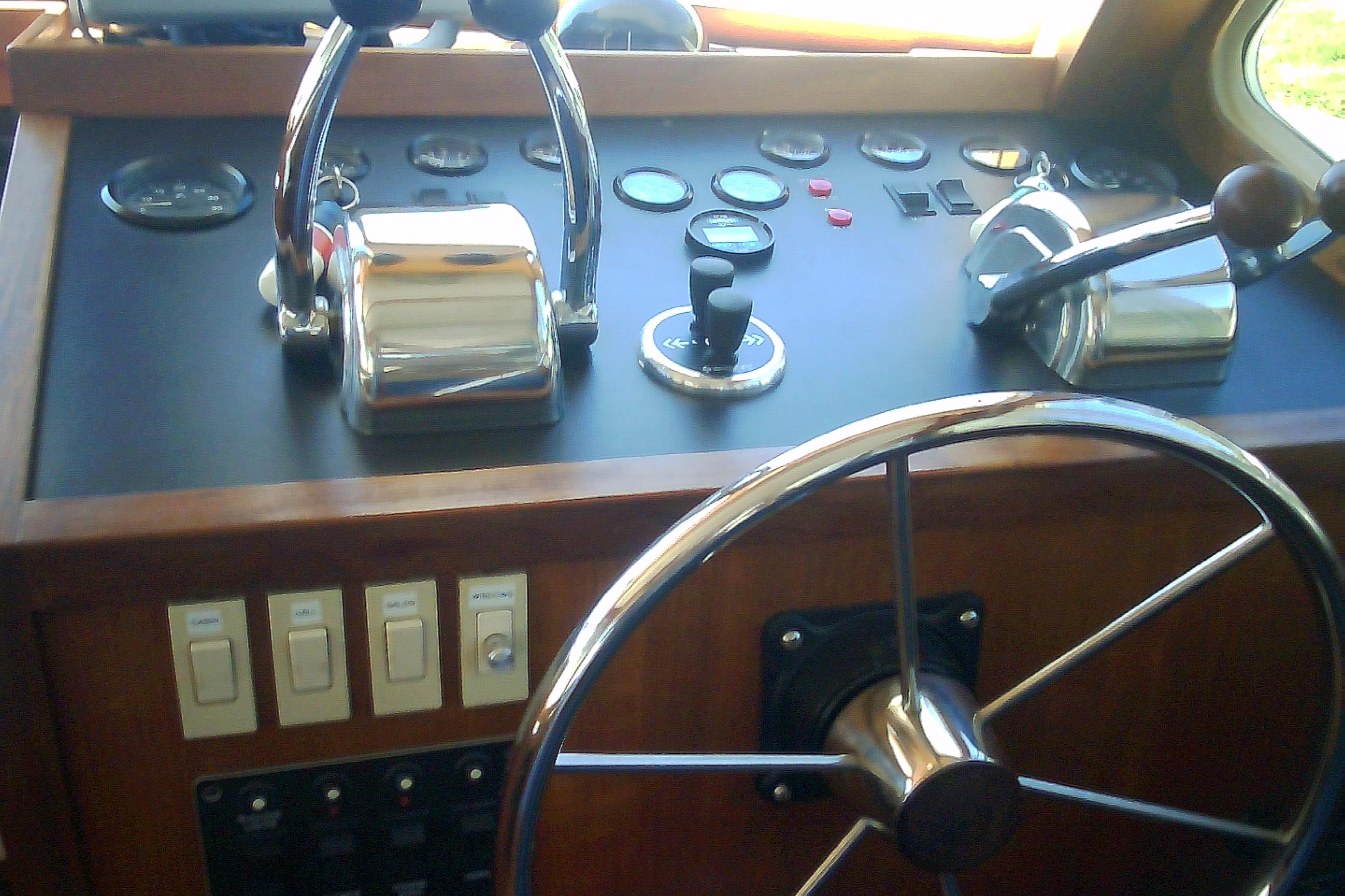 Helm of 1999 Sabre 34 boat with steering wheel and control panel.