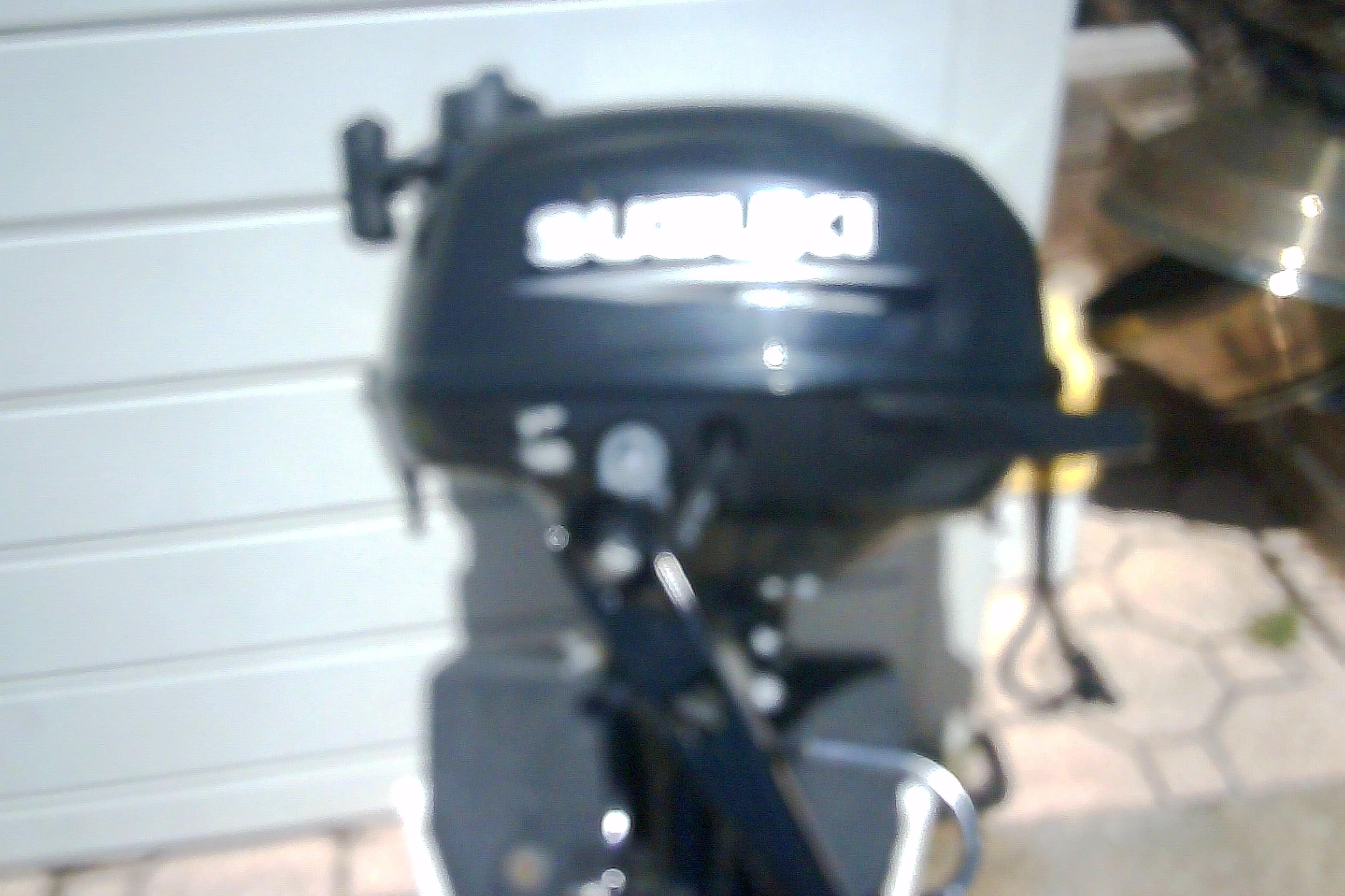 Blurred image of a Suzuki outboard motor, Sabre 34, 1999 model.