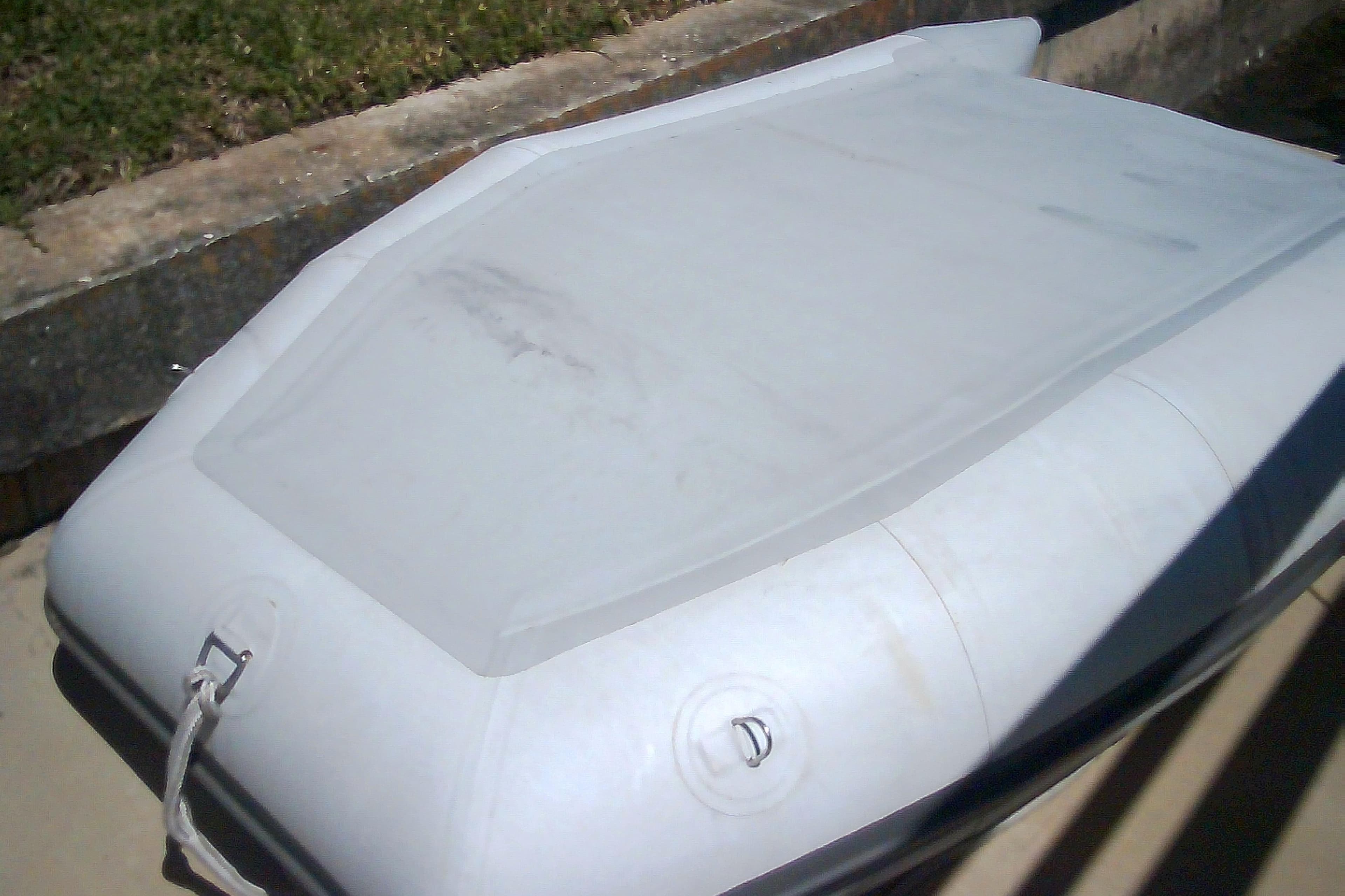 Inflatable boat on concrete surface, Sabre 34 model, 1999.