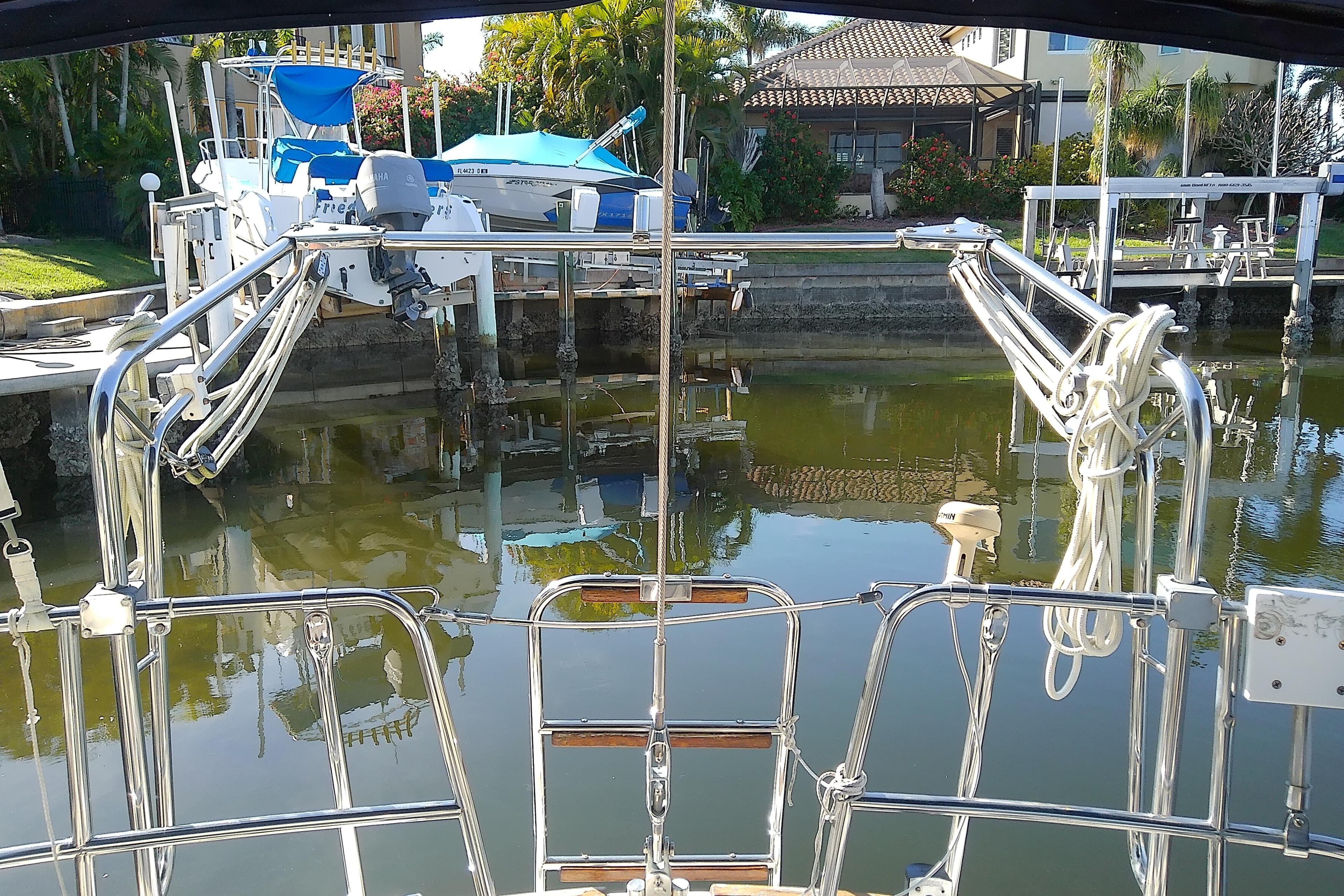 Sailboat docked in marina, Pearson 36-2, 1988 model, with polished railings and calm water.