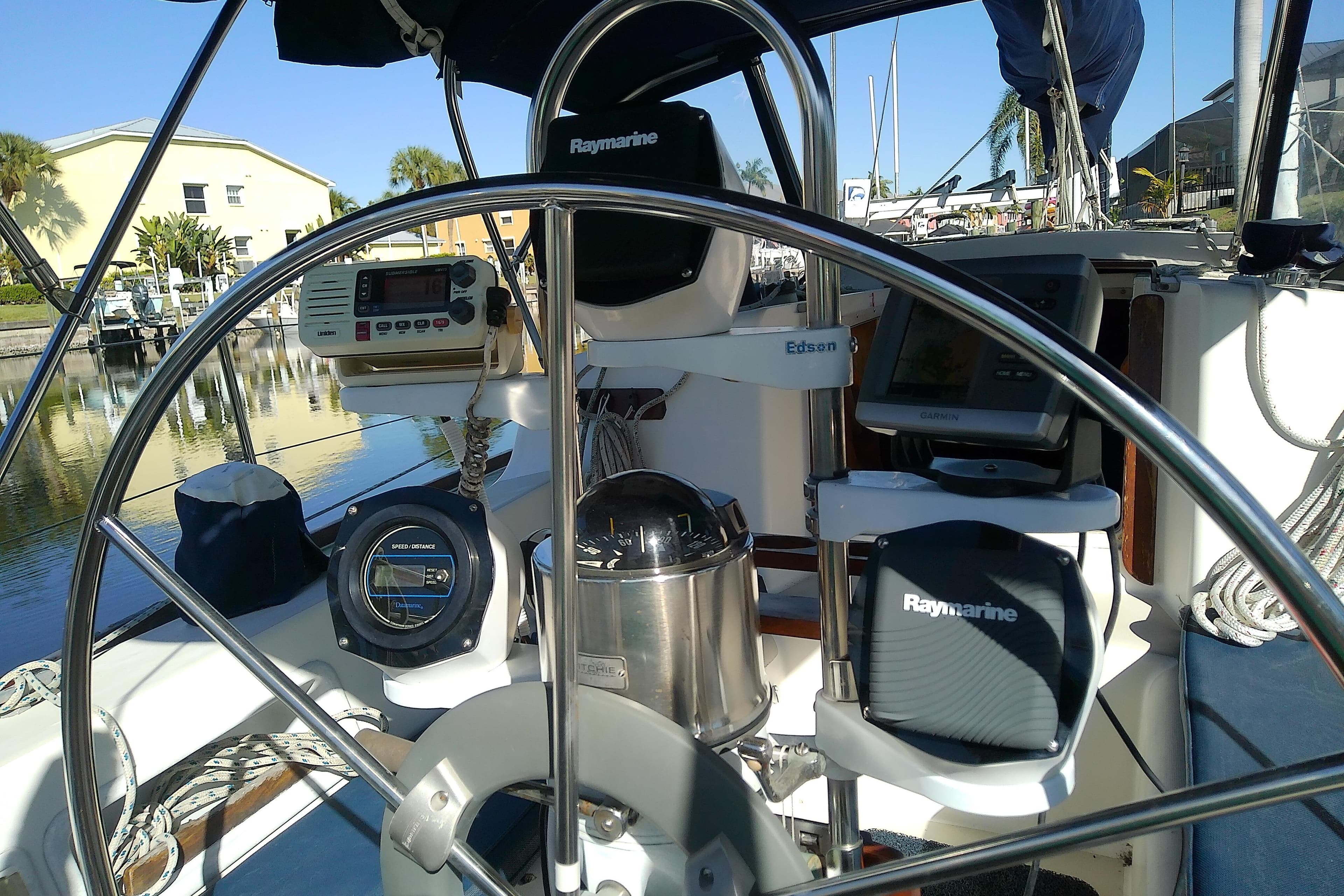 Cockpit of 1988 Pearson 36-2 sailboat with navigation equipment and steering wheel.