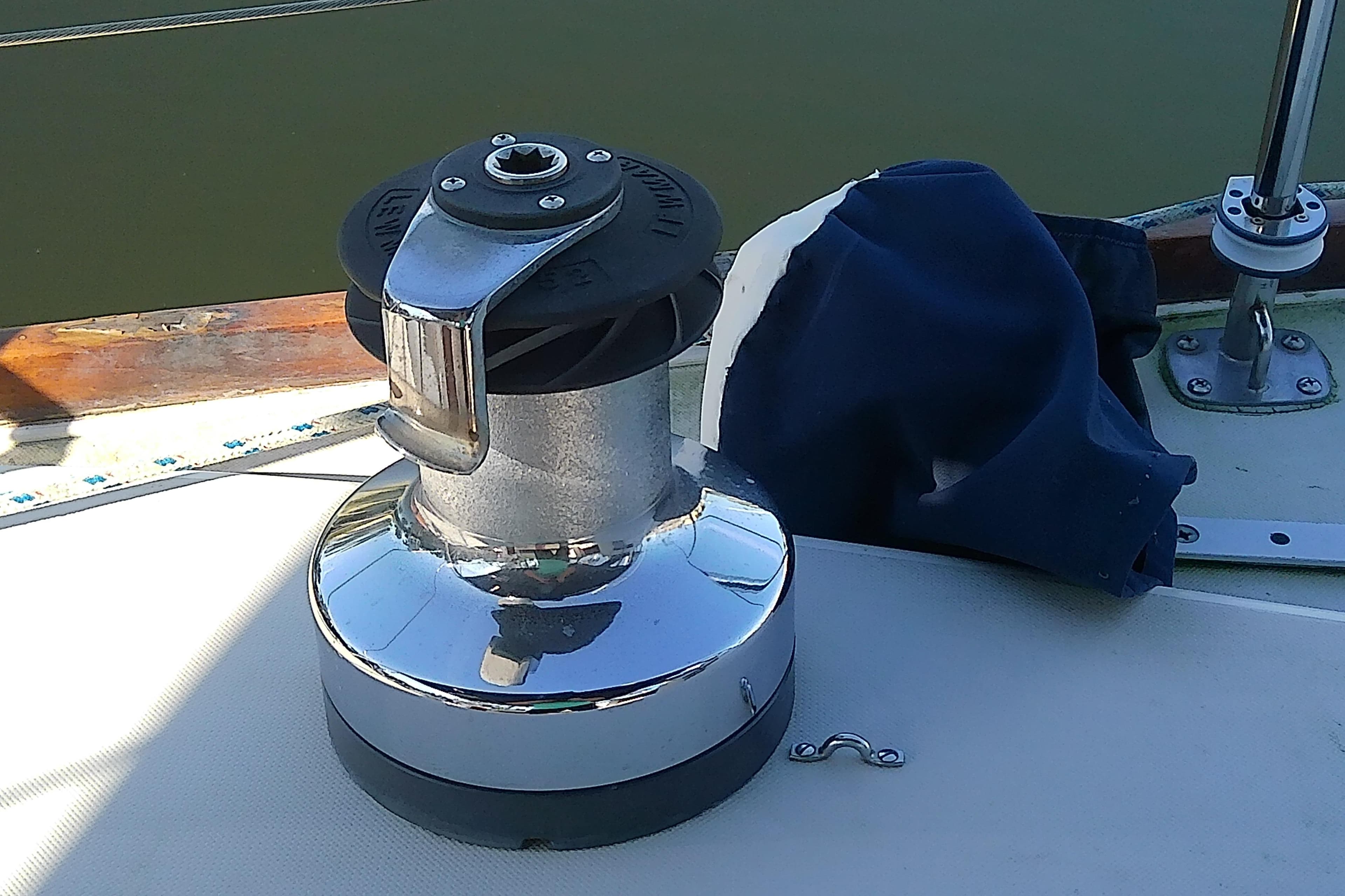 Sailboat winch on 1988 Pearson 36-2 deck, with blue cover nearby.