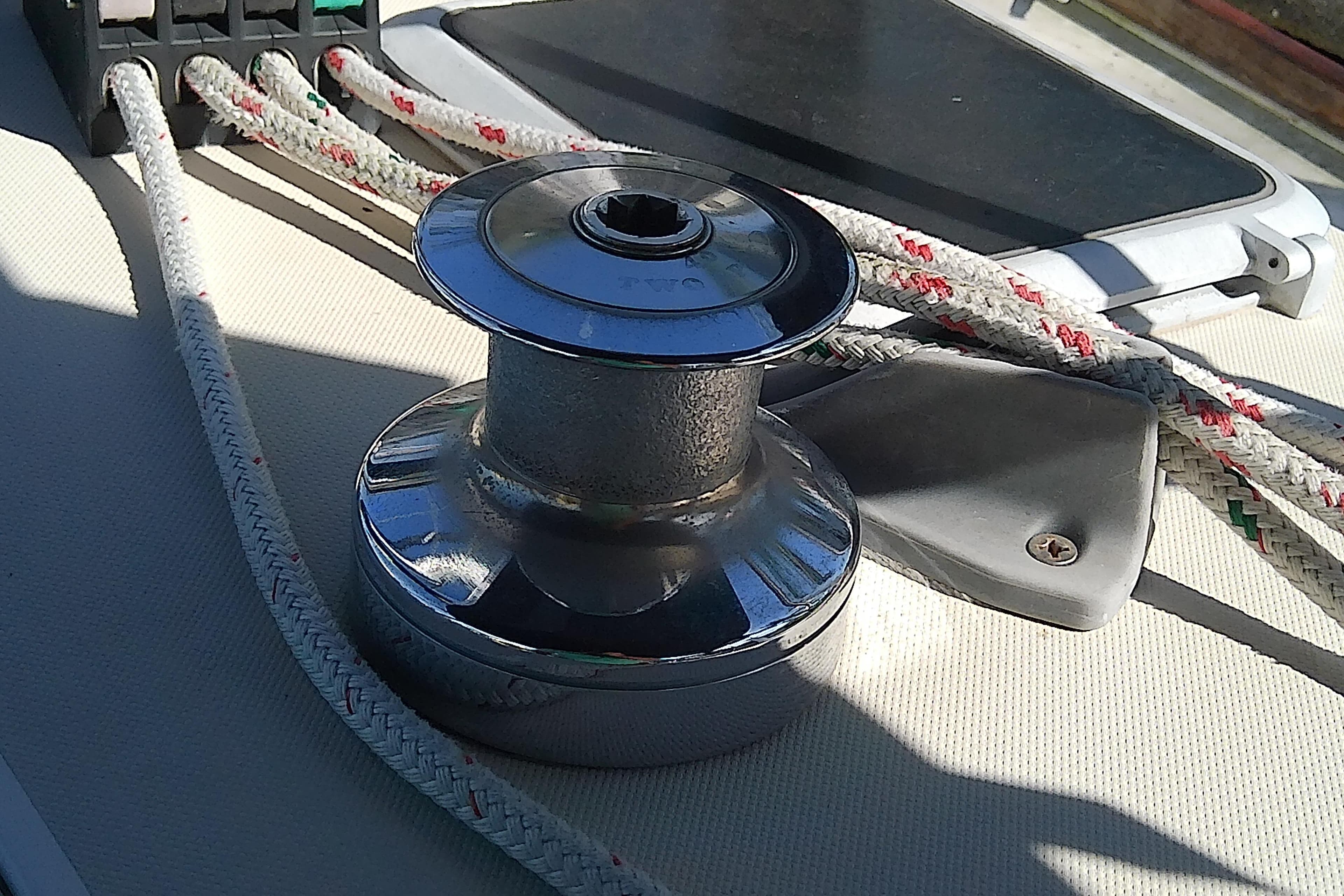 Winch and ropes on 1988 Pearson 36-2 sailboat deck in sunlight.