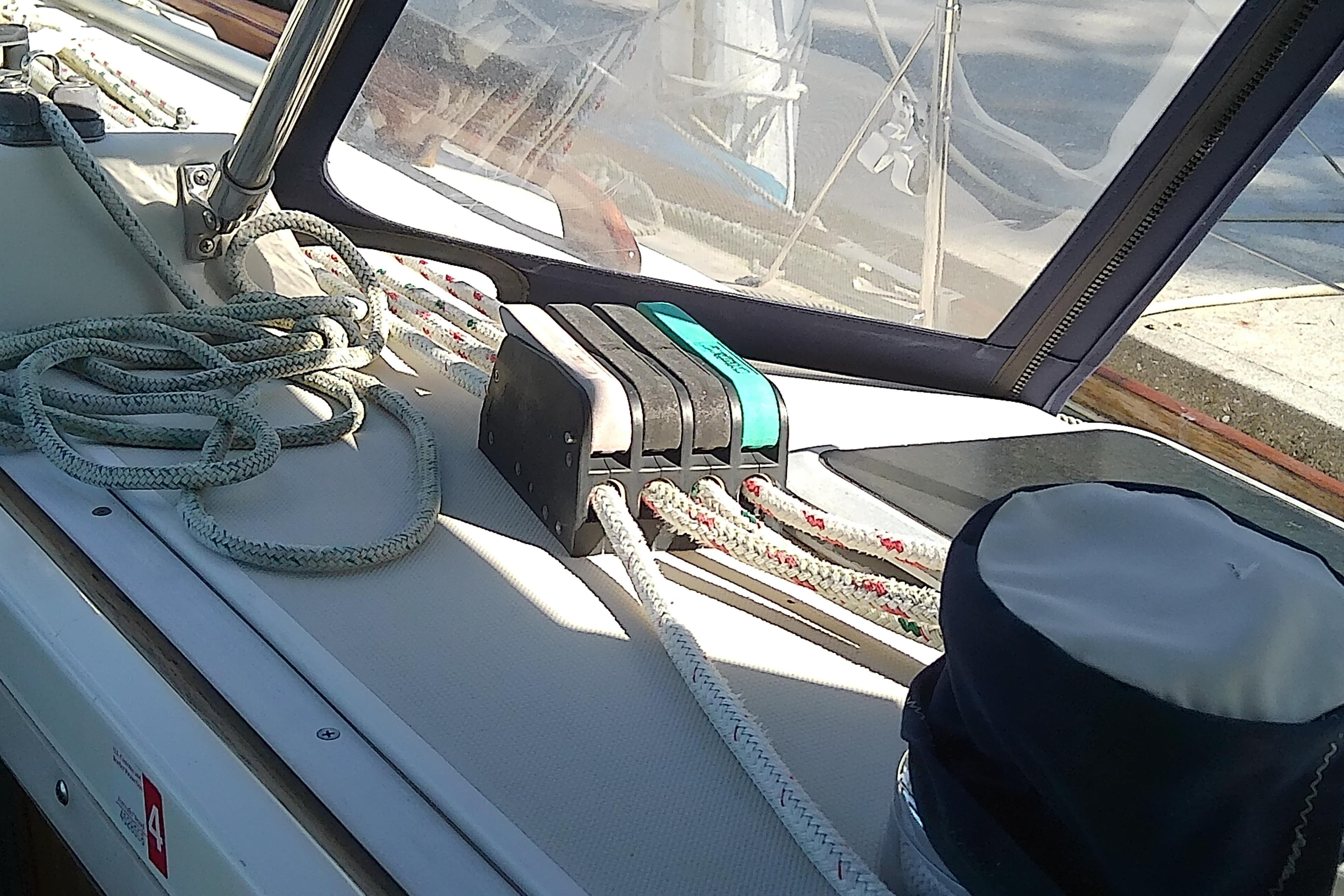 Deck of 1988 Pearson 36-2 sailboat with ropes and winch handle.