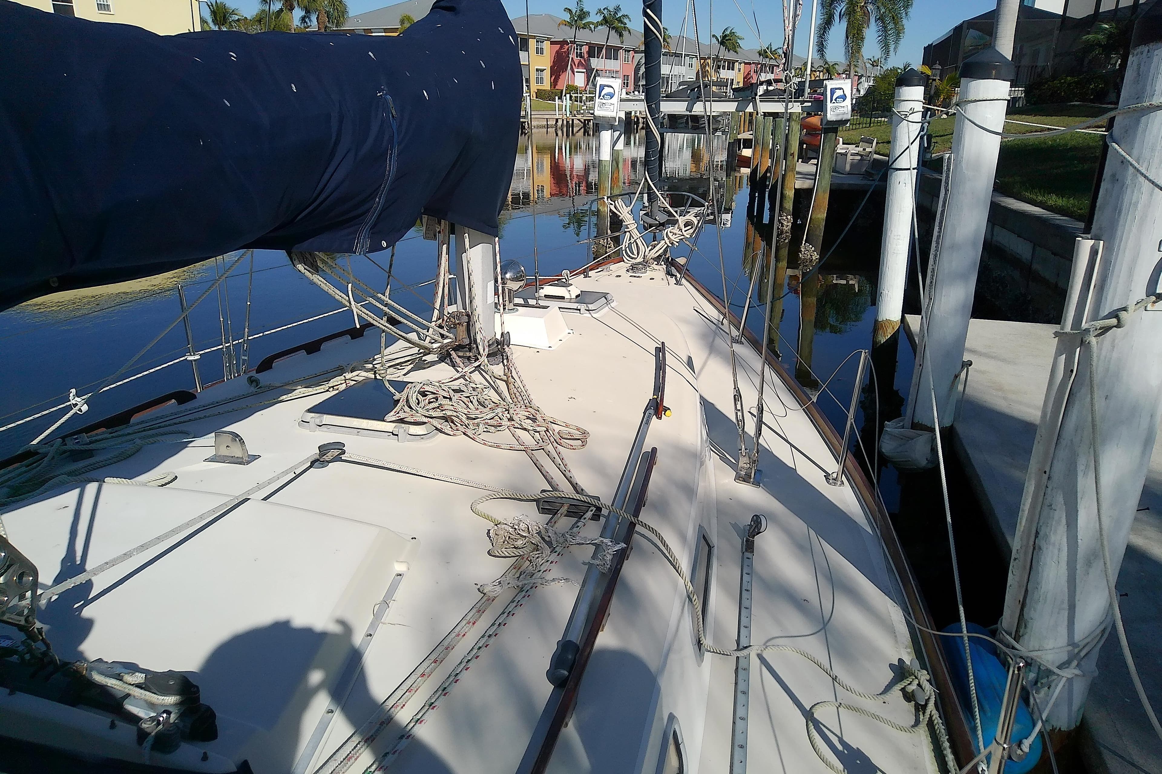 1988 Pearson 36-2 sailboat docked, featuring rigging and covered mainsail.