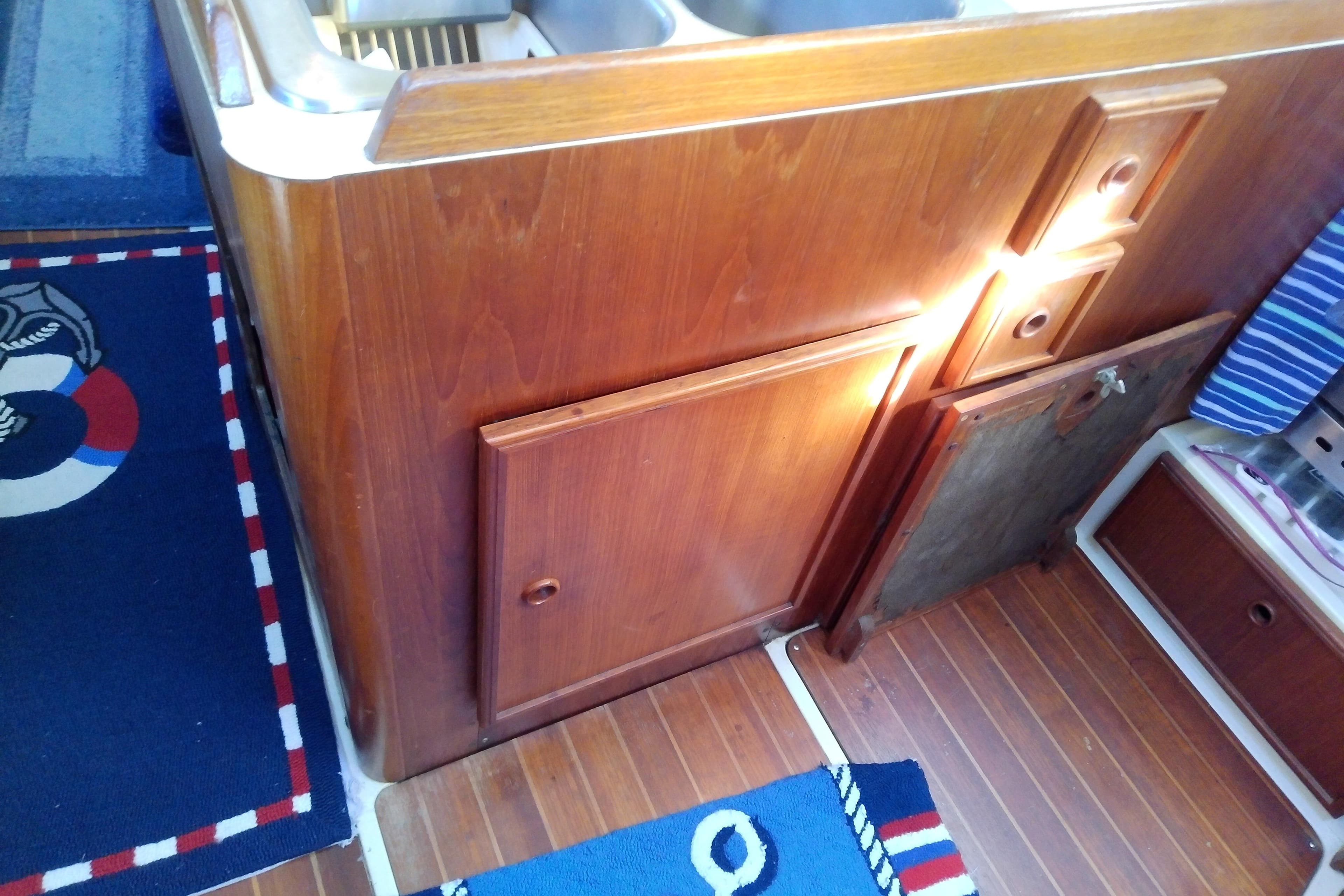 1988 Pearson 36-2 yacht interior with wooden cabinetry and nautical-themed decor.