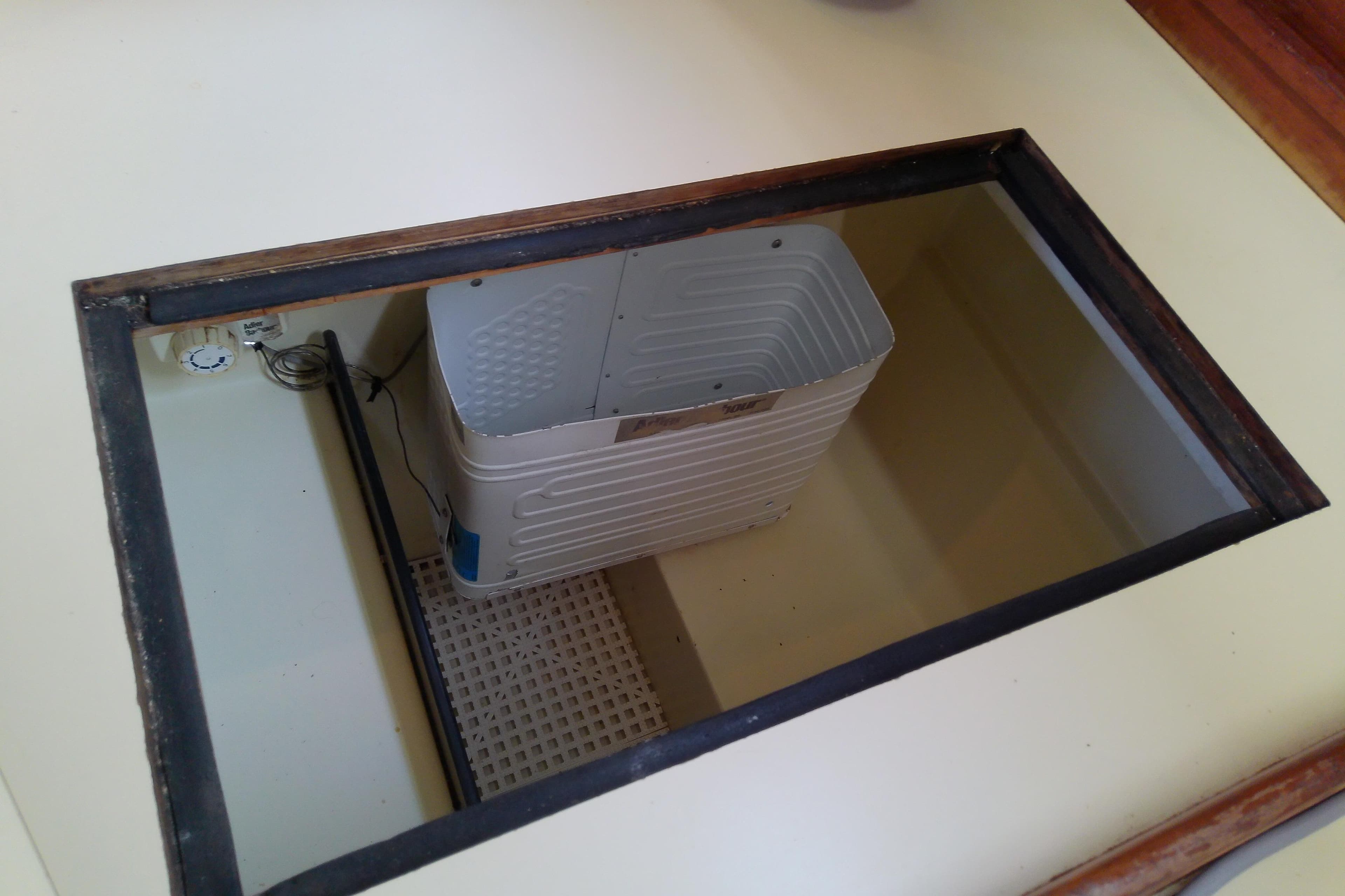 Open compartment in 1988 Pearson 36-2 boat, featuring a storage bin.