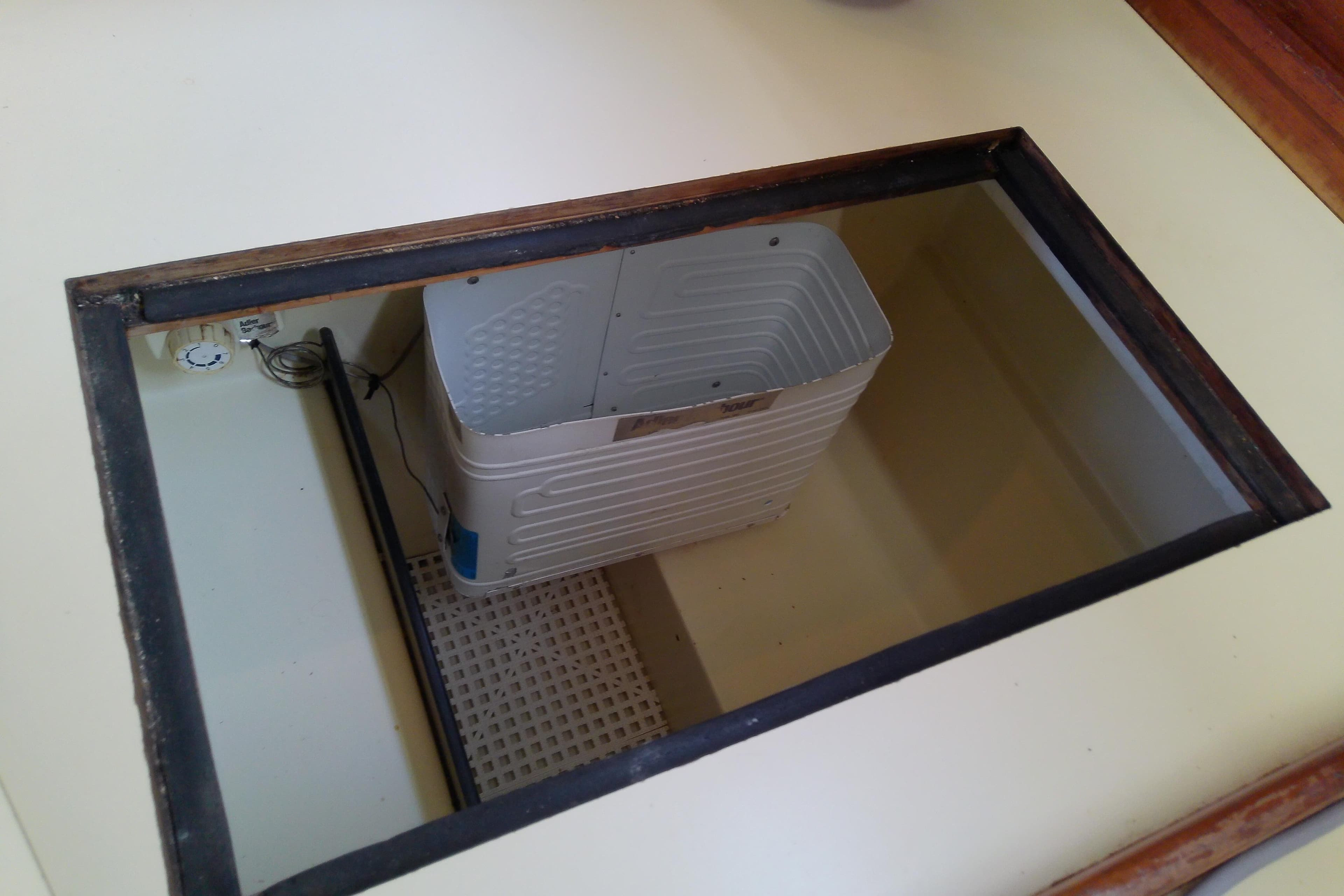 Open compartment in 1988 Pearson 36-2 boat, revealing storage space and wiring.