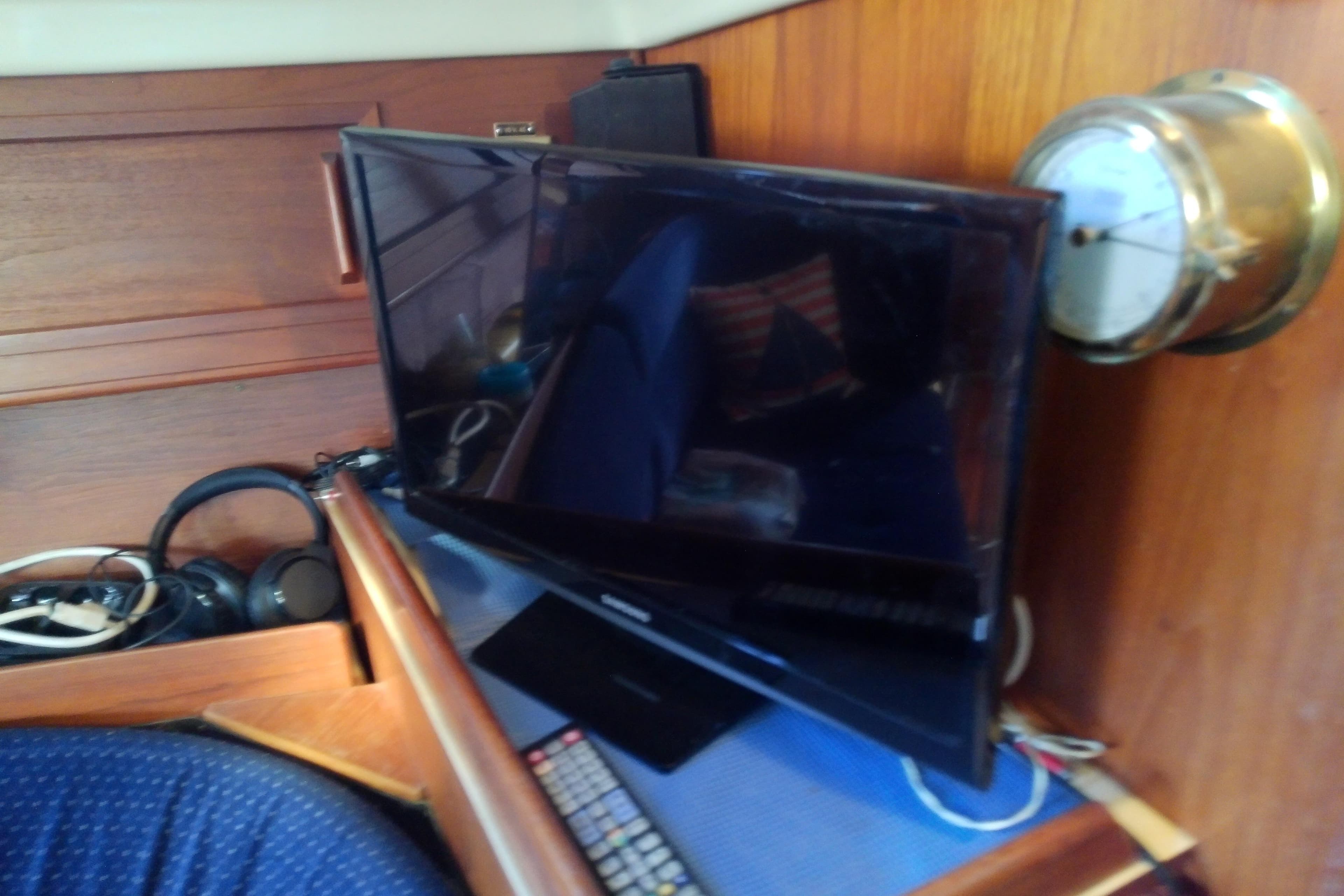 Interior of 1988 Pearson 36-2 yacht with TV, headphones, and nautical decor.