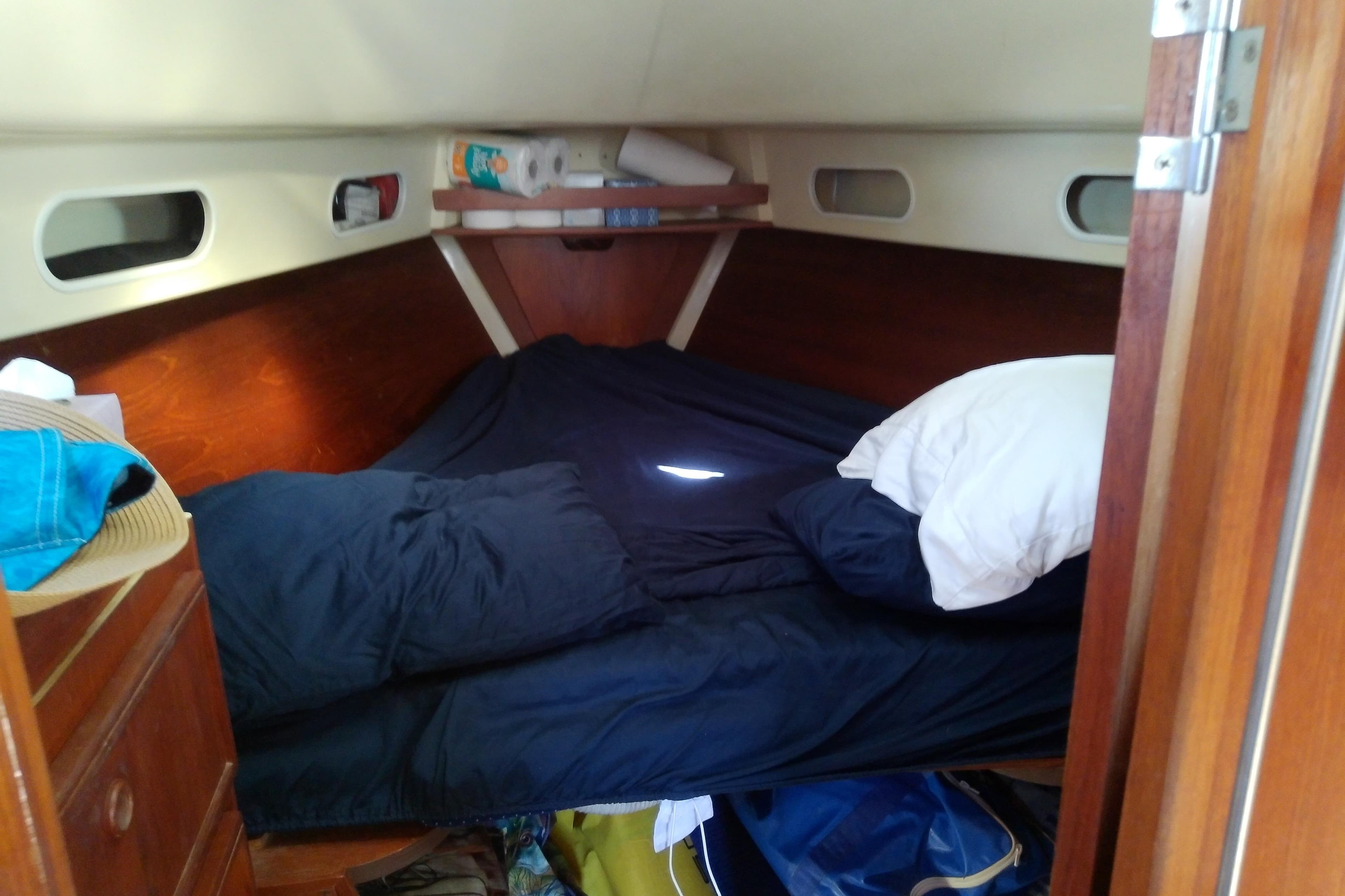 Cozy cabin interior of a 1988 Pearson 36-2 sailboat with a neatly made bed.