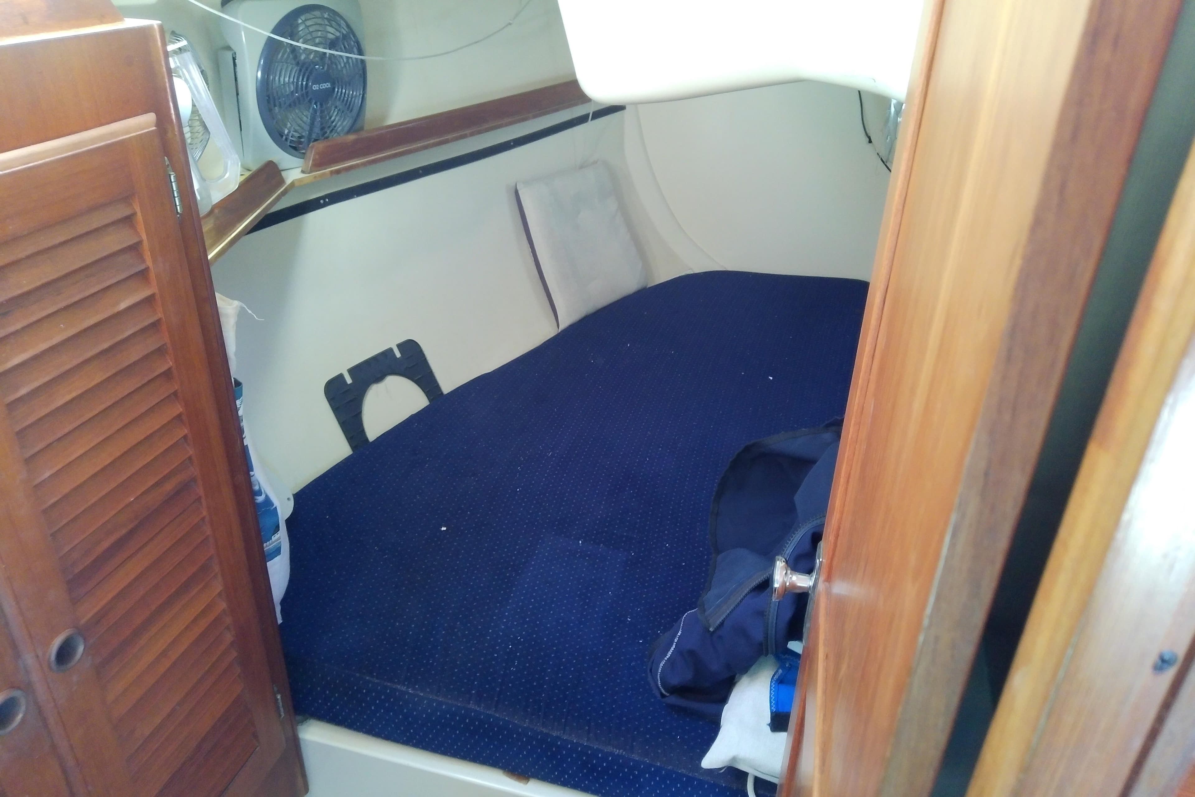 1988 Pearson 36-2 sailboat cabin interior with blue bedding and wooden accents.