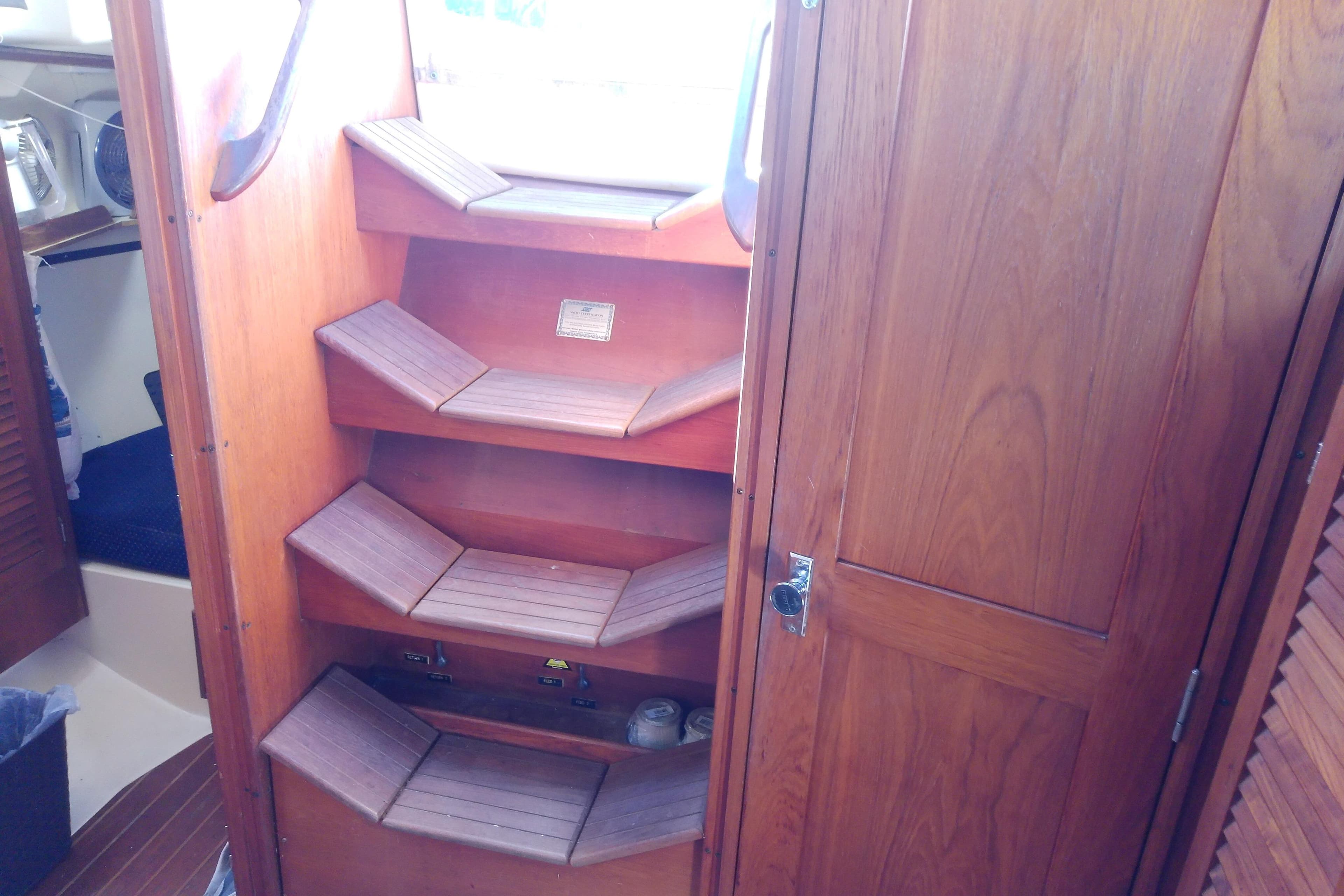 Interior of 1988 Pearson 36-2 sailboat with wooden steps and cabinetry.