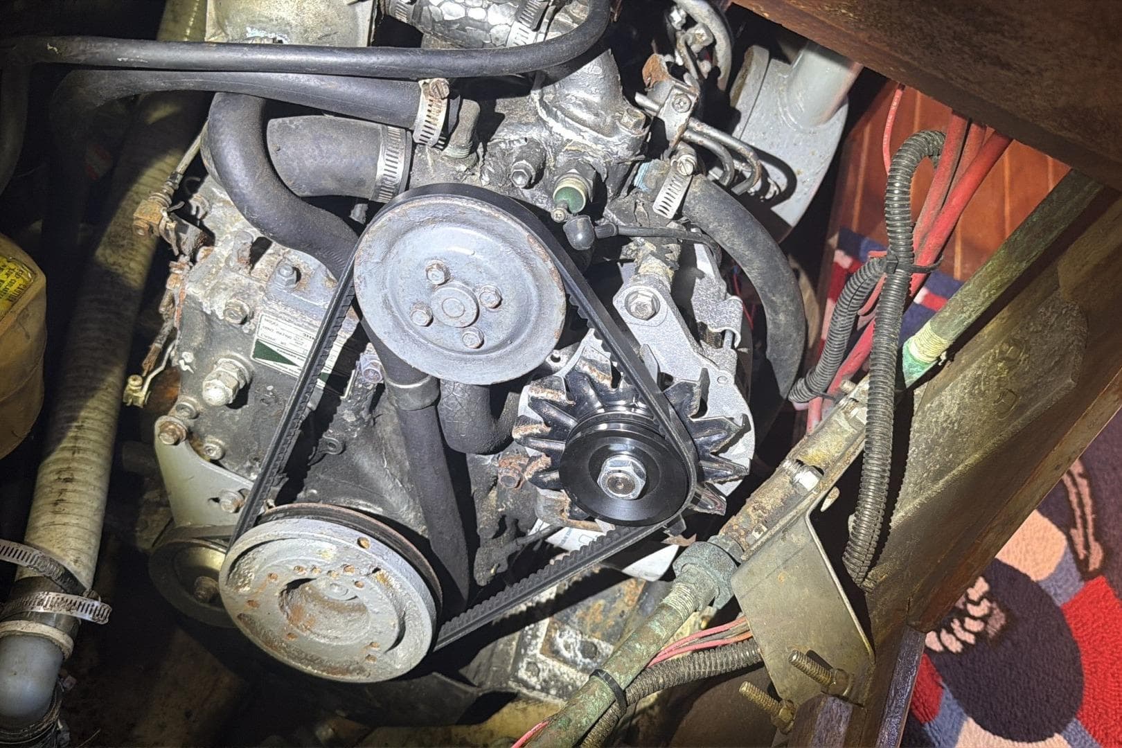 Engine compartment of a 1988 Pearson 36-2 sailboat, showing belts and pulleys.