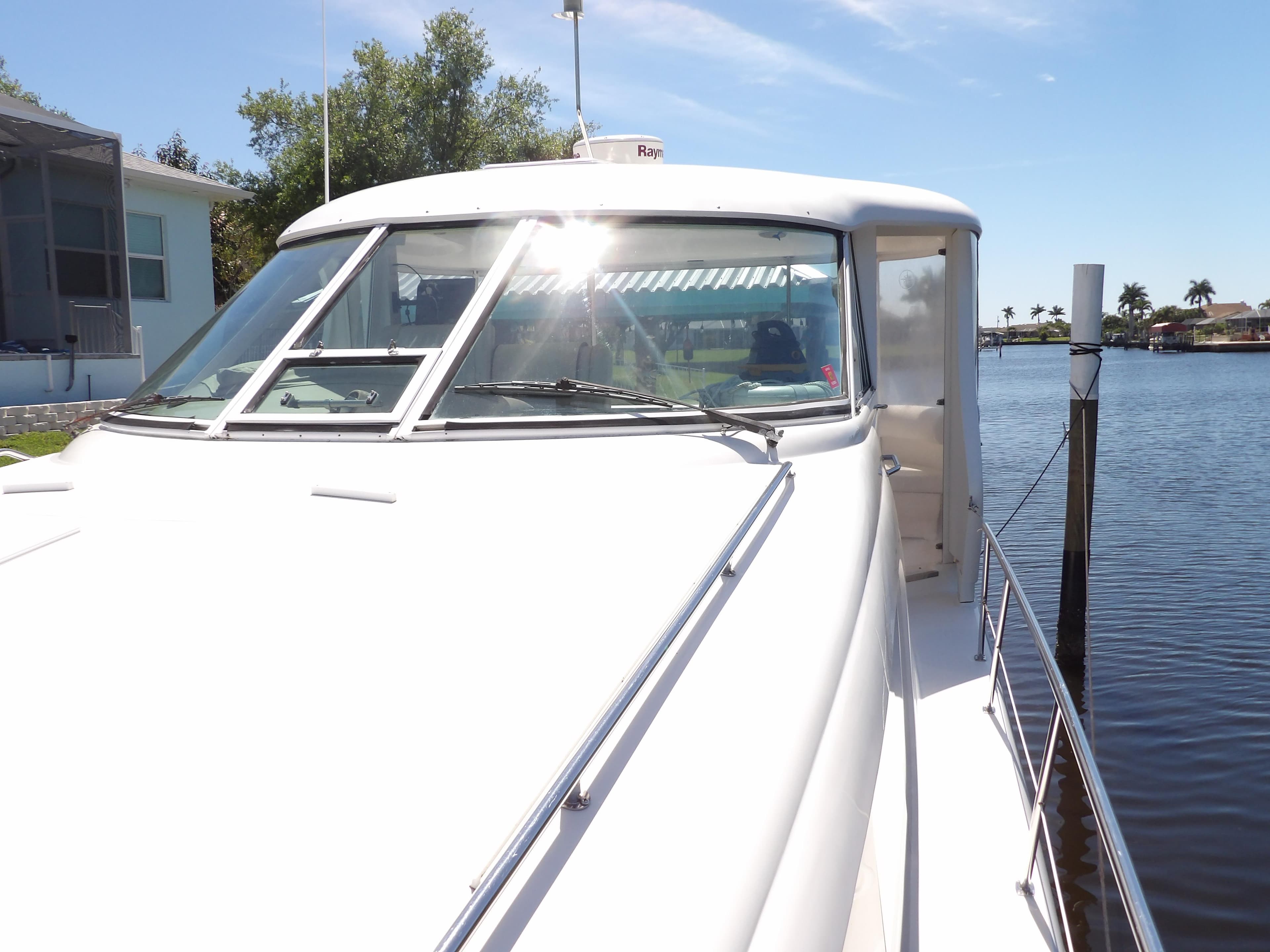 2003 Sea Ray 390 Motor Yacht docked by the water.