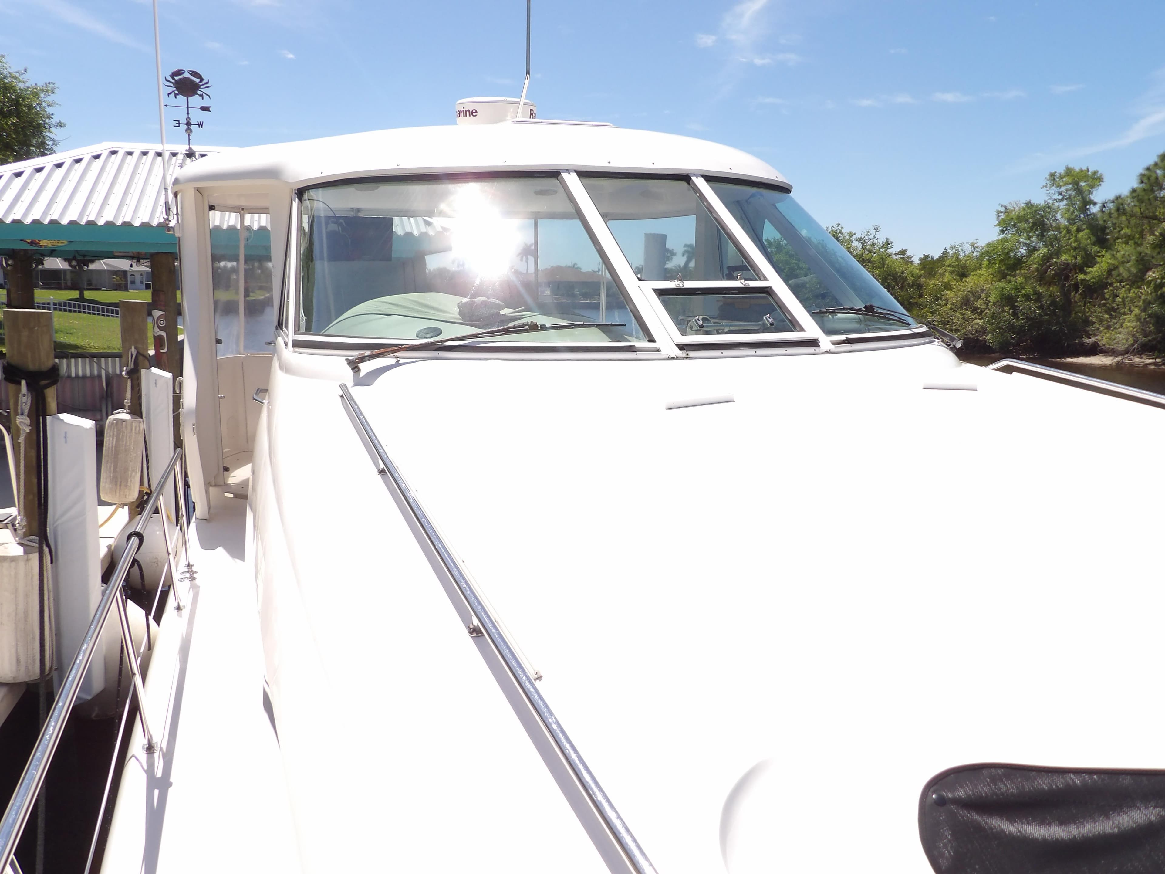 2003 Sea Ray 390 Motor Yacht docked under clear blue sky.
