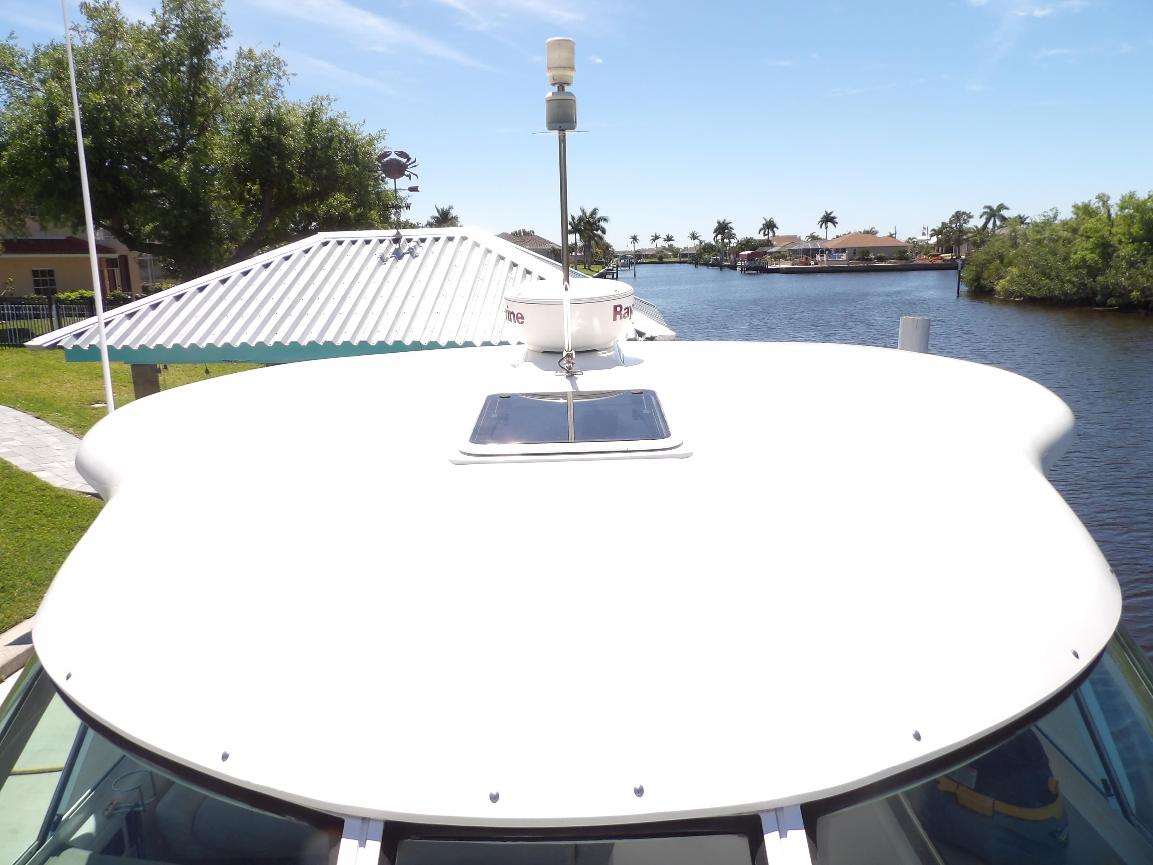 2003 Sea Ray 390 Motor Yacht bow view on a sunny day by the water.