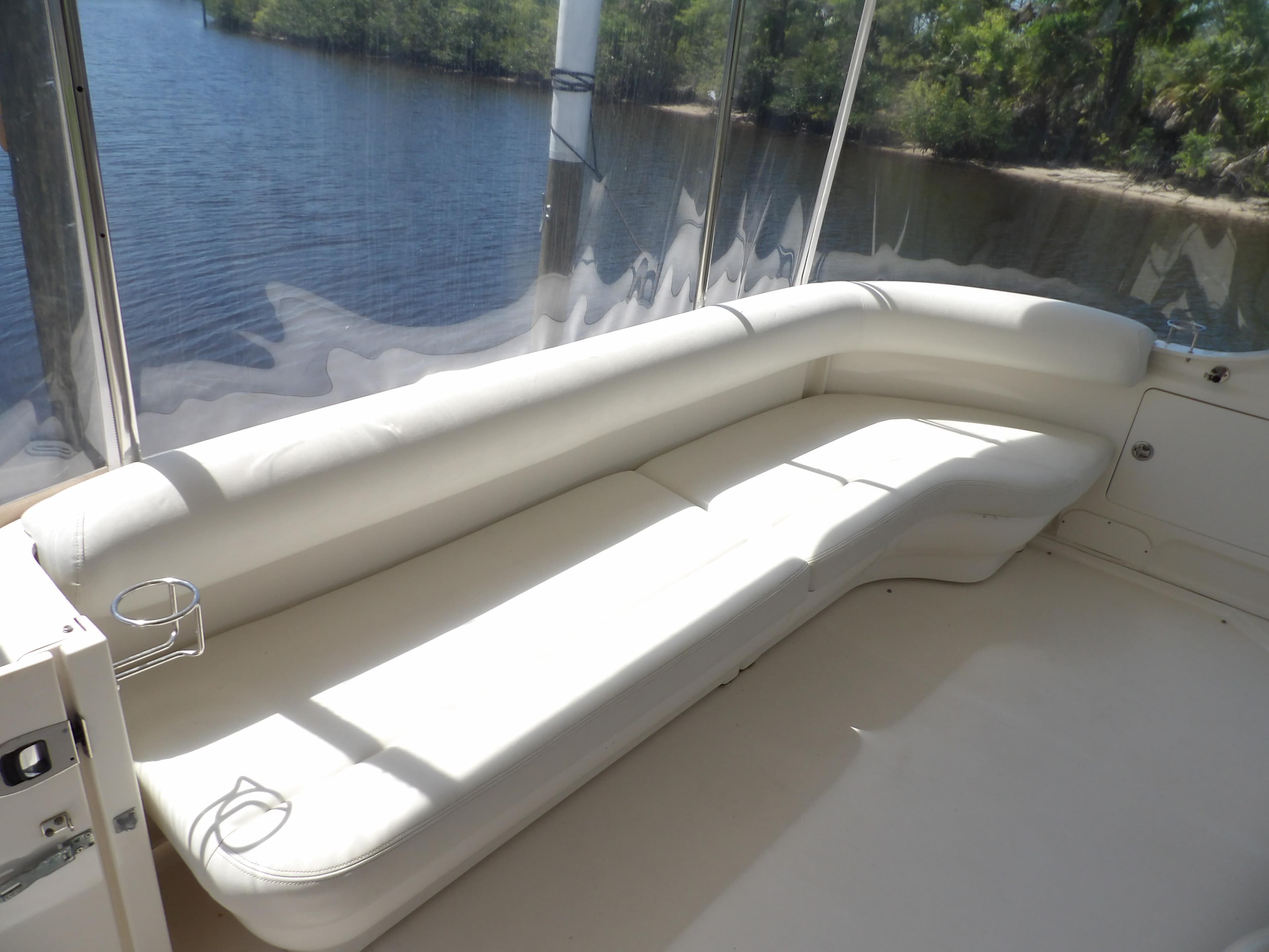 2003 Sea Ray 390 Motor Yacht with white leather seating on deck.