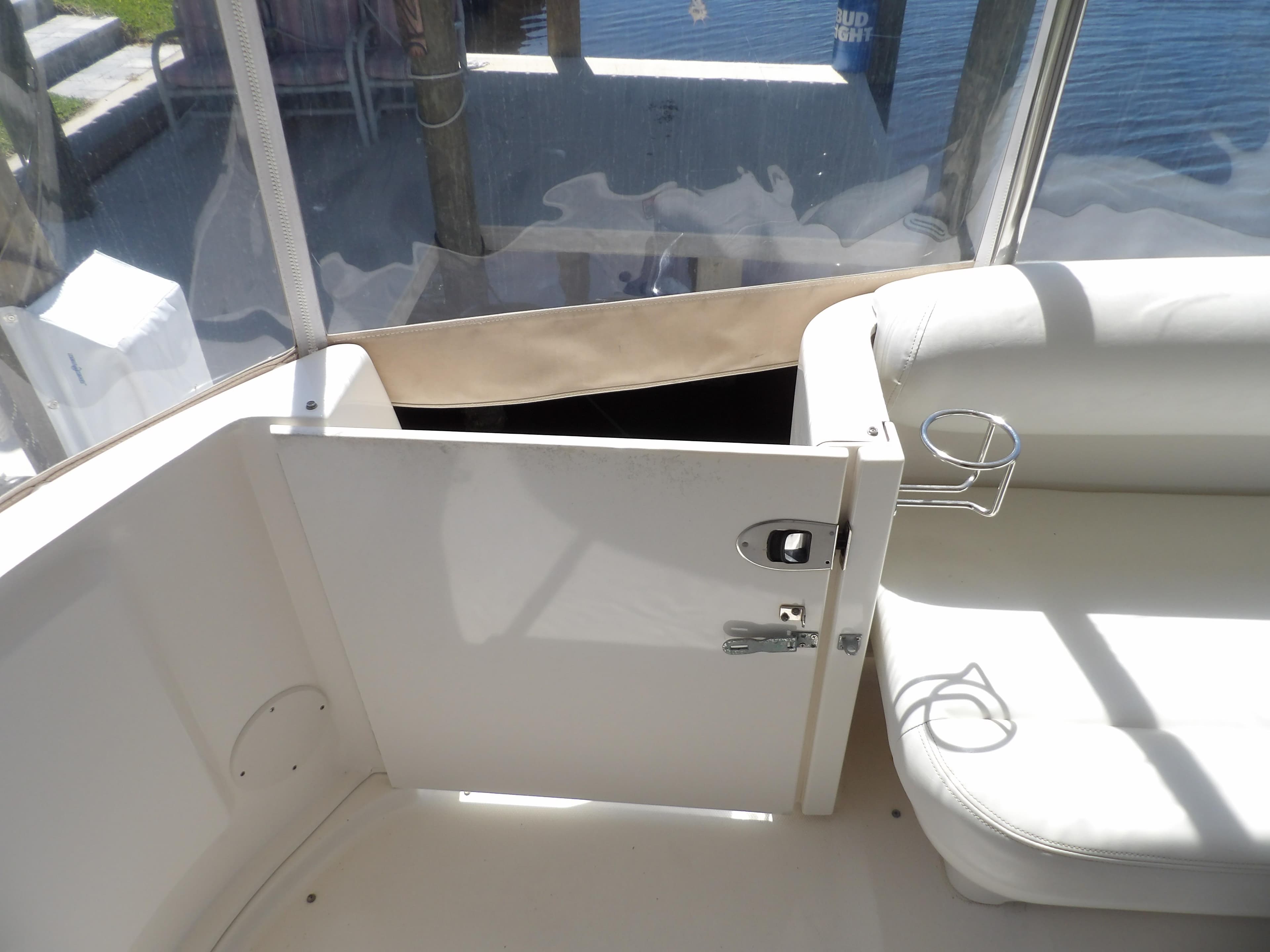 Sea Ray 390 Motor Yacht 2003 interior seating area with open door and cup holder.