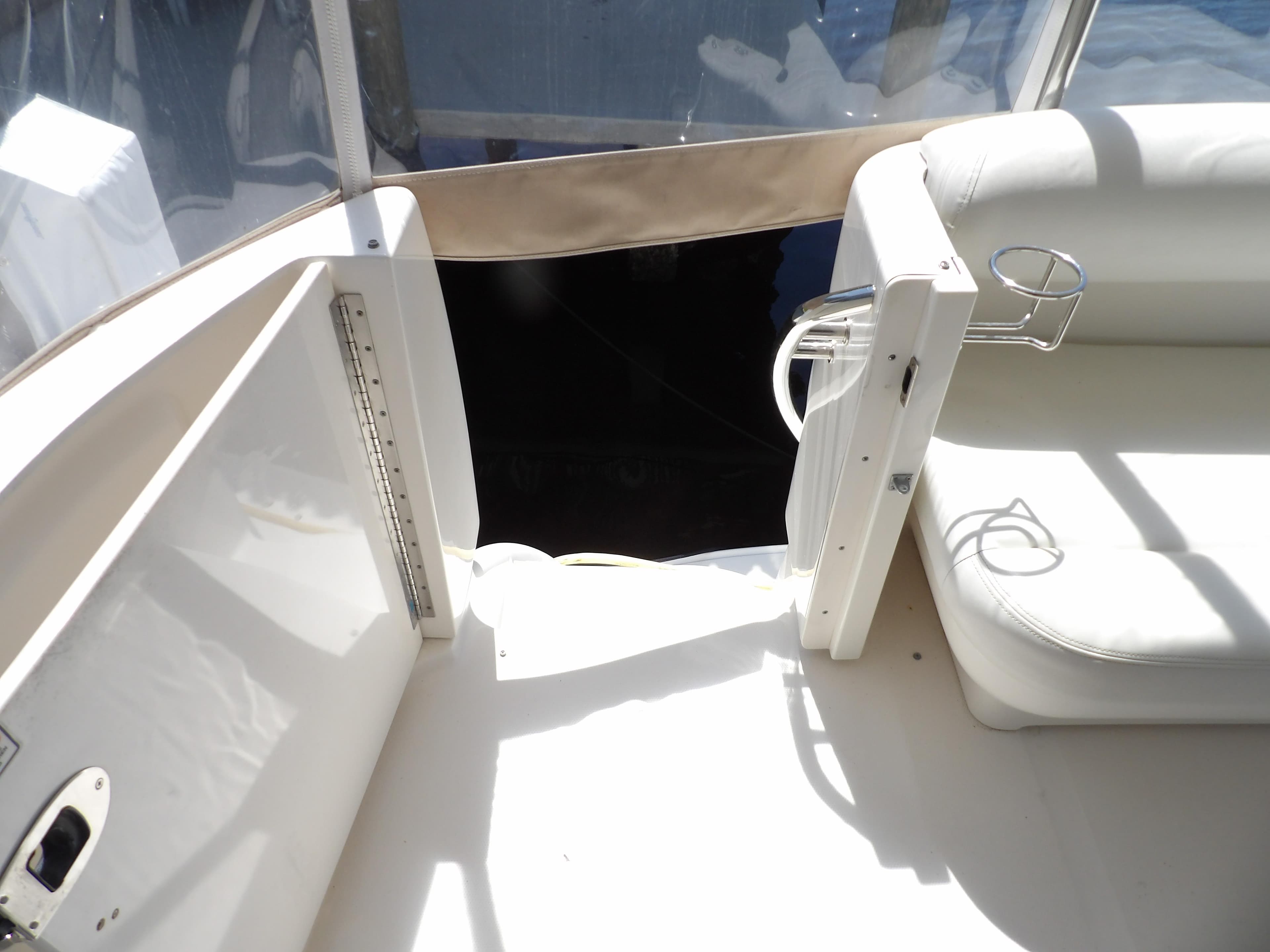 2003 Sea Ray 390 Motor Yacht interior seating area with cup holders.