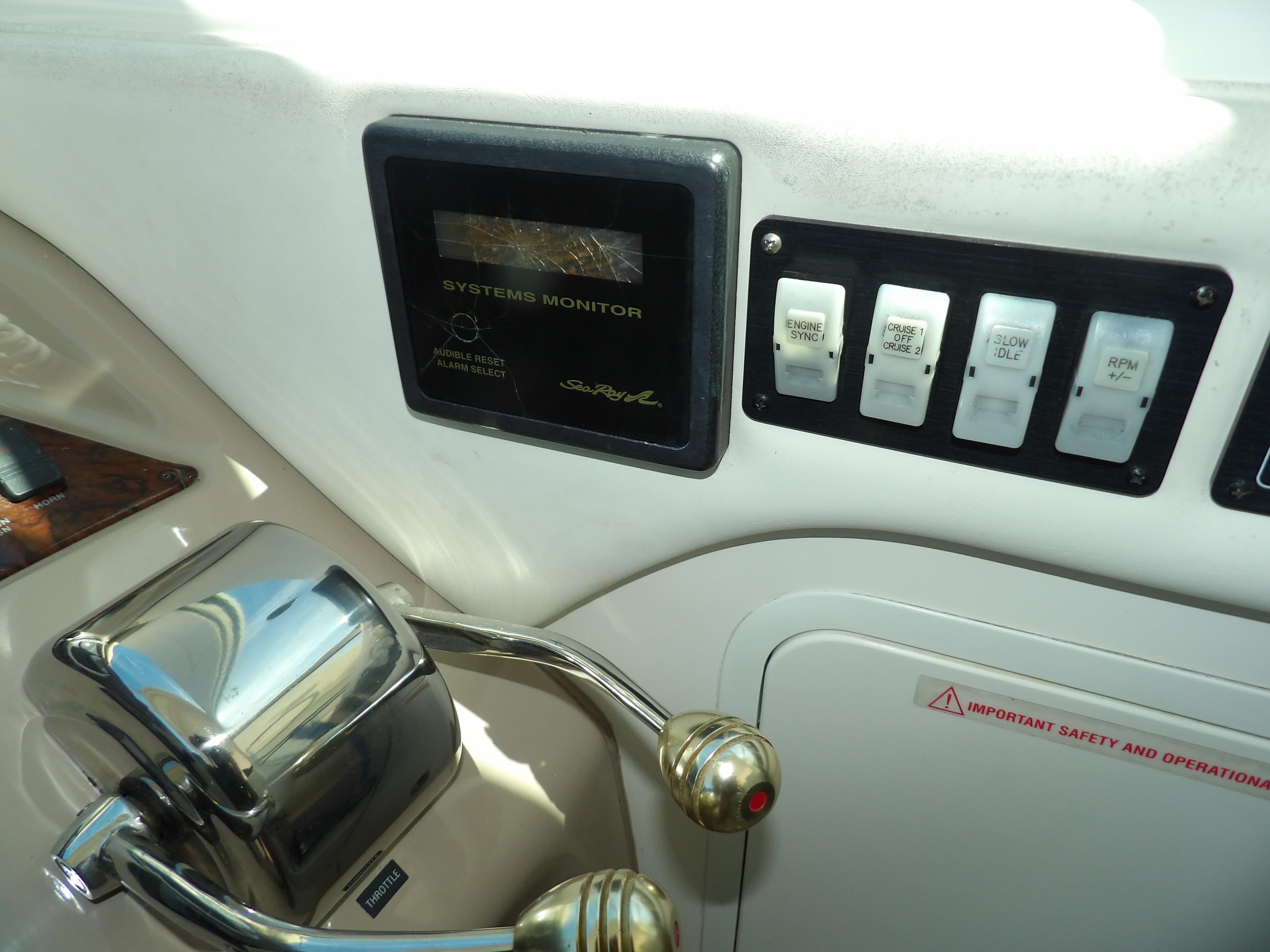 Control panel of a 2003 Sea Ray 390 Motor Yacht with system monitor and switches.
