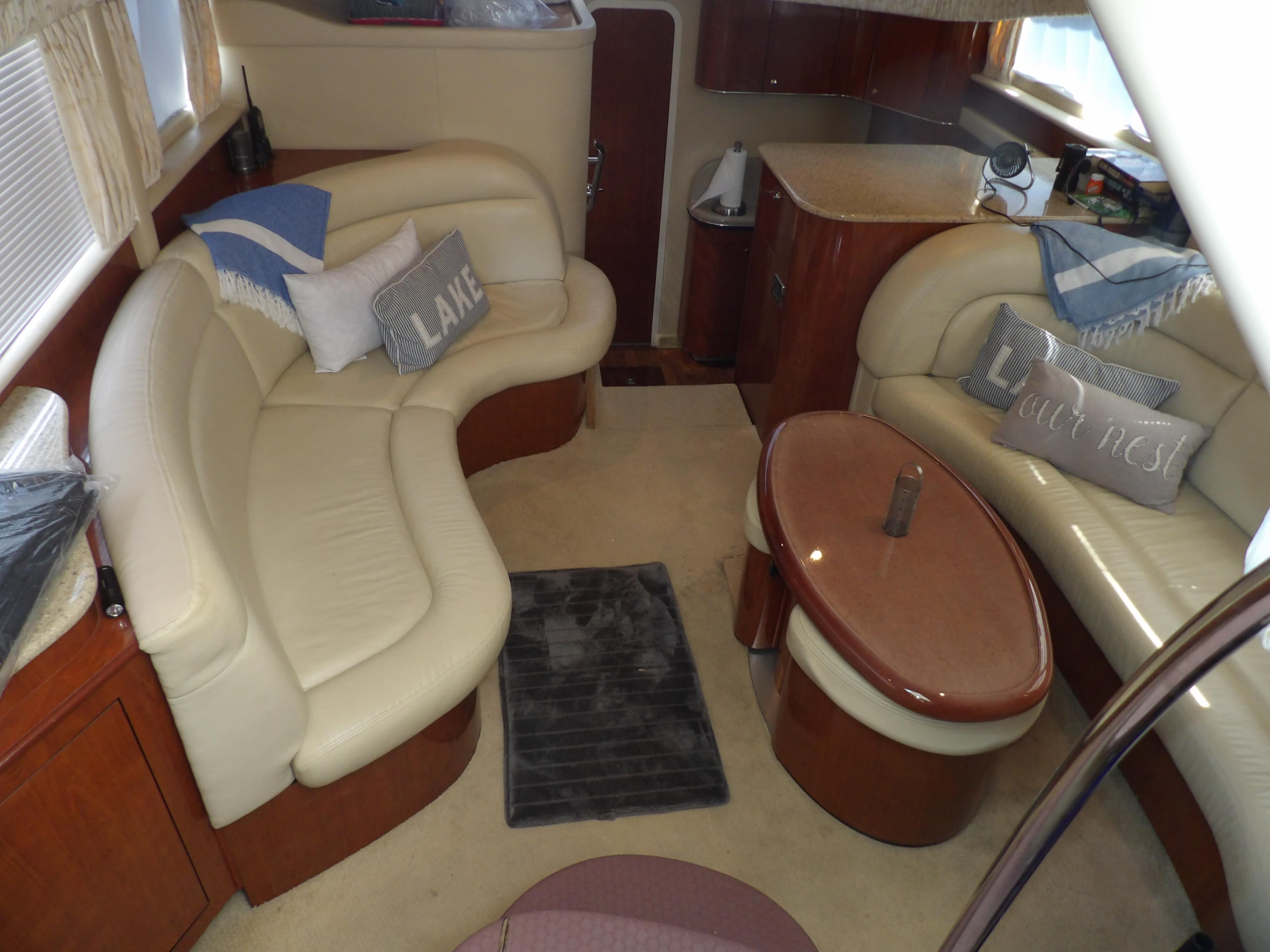 Interior of 2003 Sea Ray 390 Motor Yacht with beige leather seating and wooden accents.