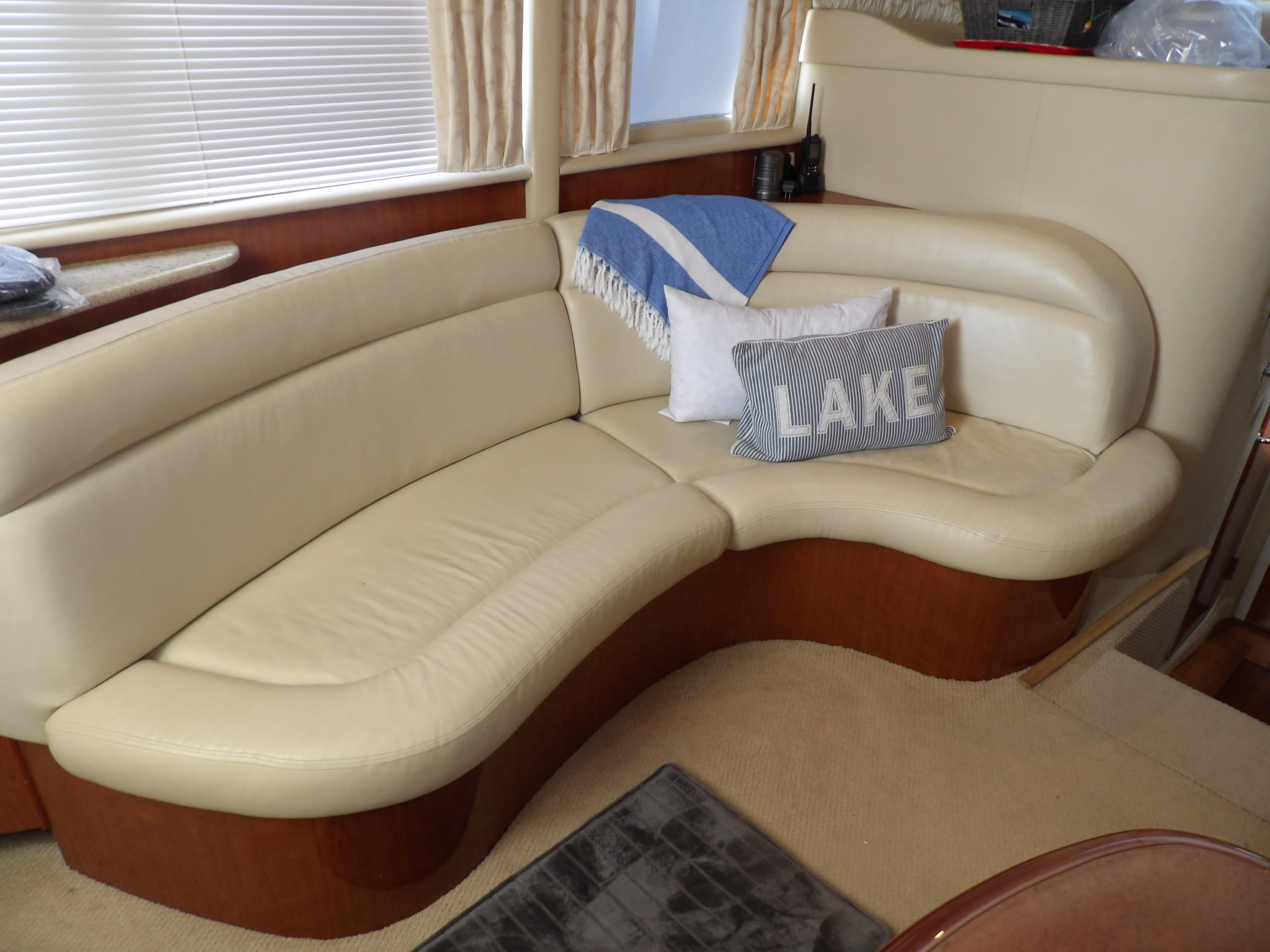 Luxurious interior of a 2003 Sea Ray 390 Motor Yacht with cream leather seating.