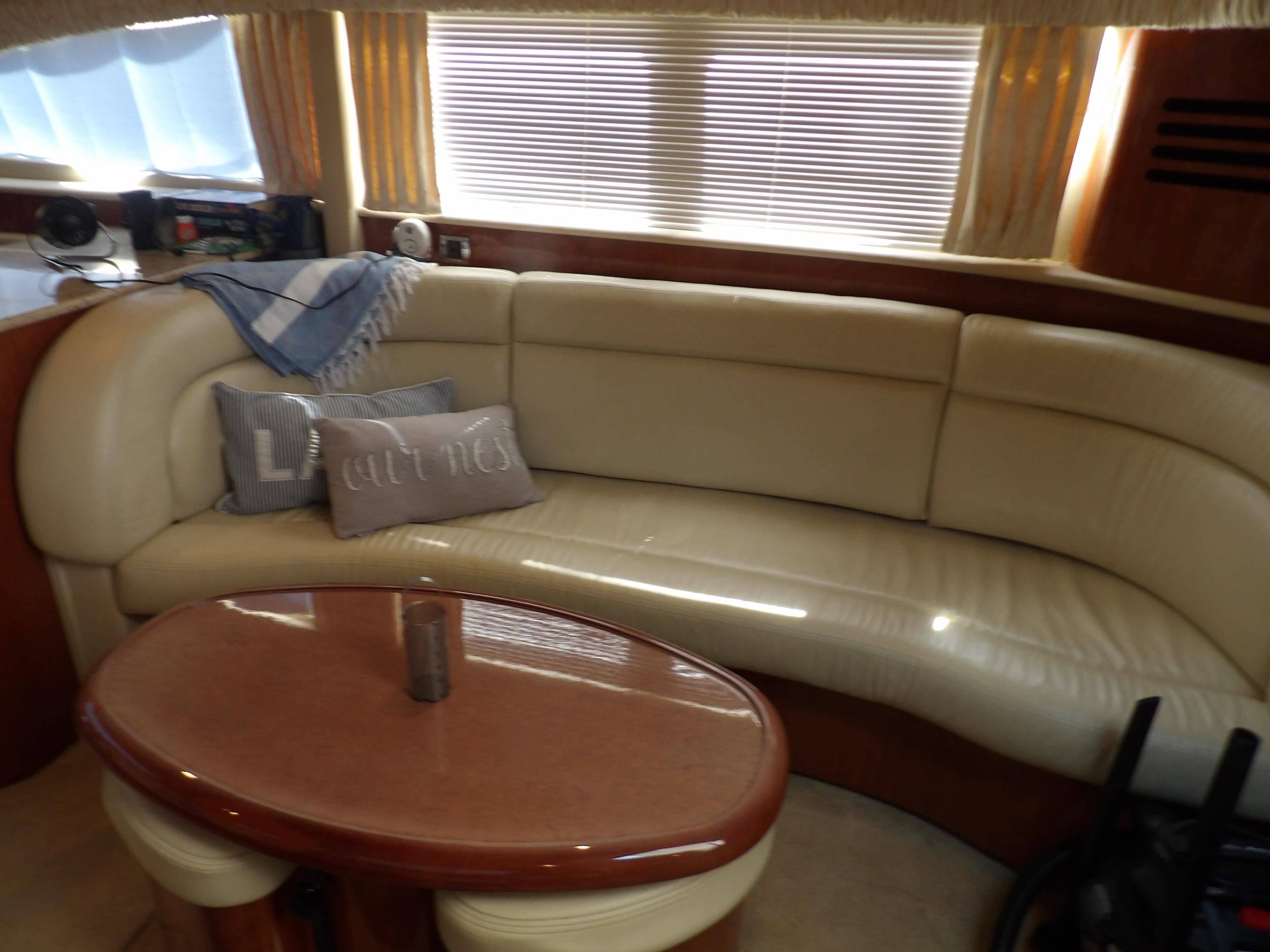 Interior of 2003 Sea Ray 390 Motor Yacht with leather seating and table.