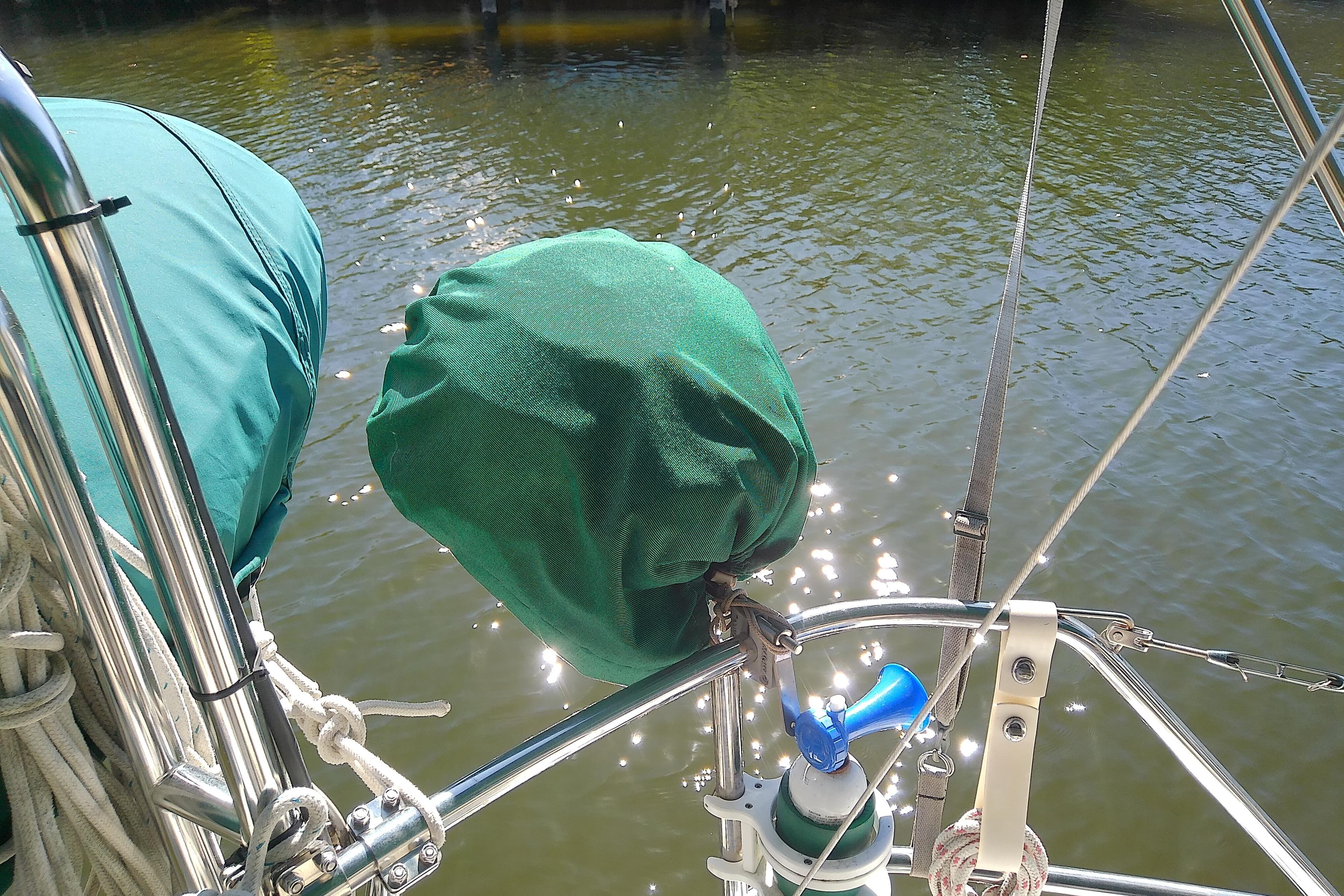 Sailboat deck with green covers and equipment, Hunter 30, 1991 model.