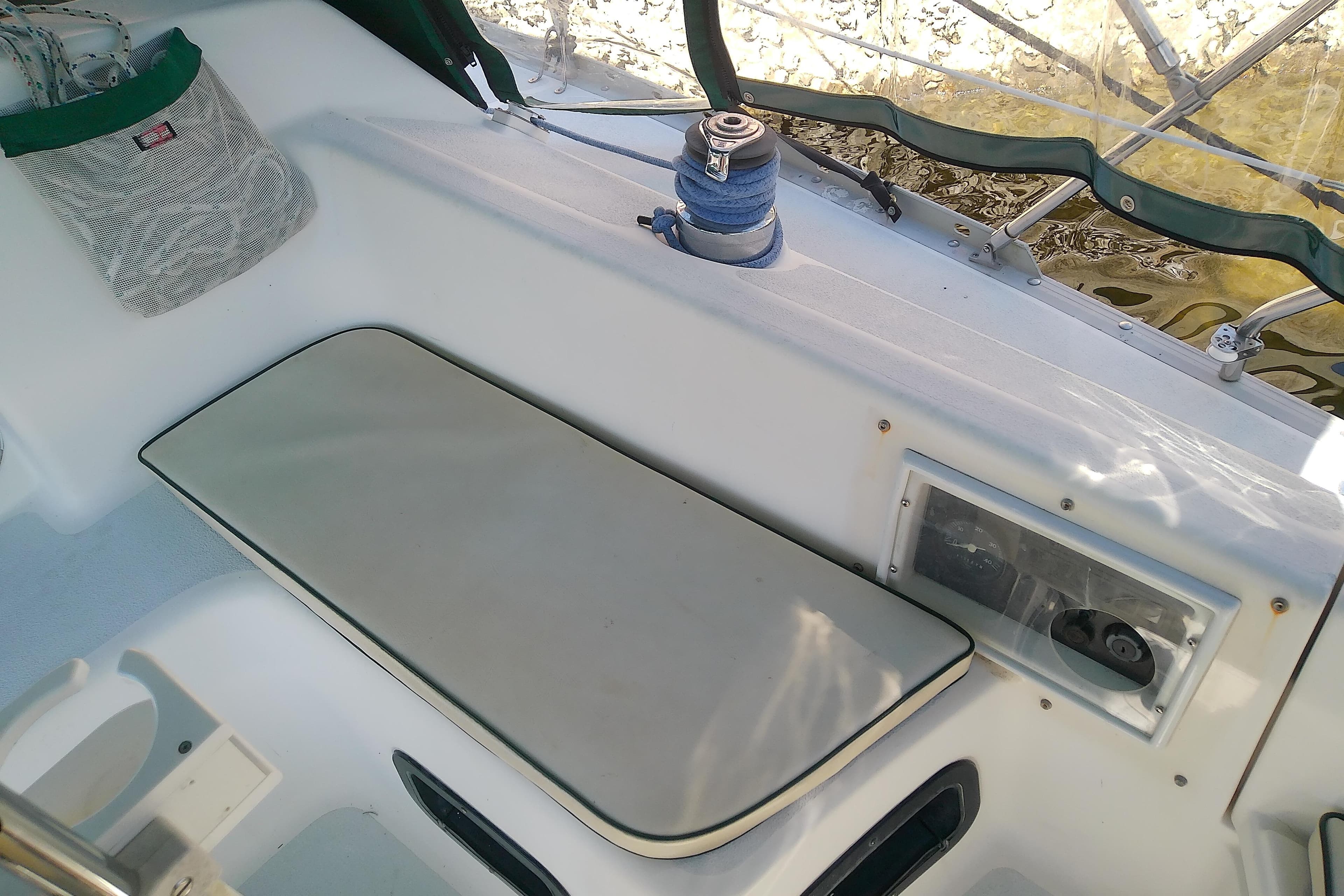 Cockpit of 1991 Hunter 30 sailboat with winch and seating area.