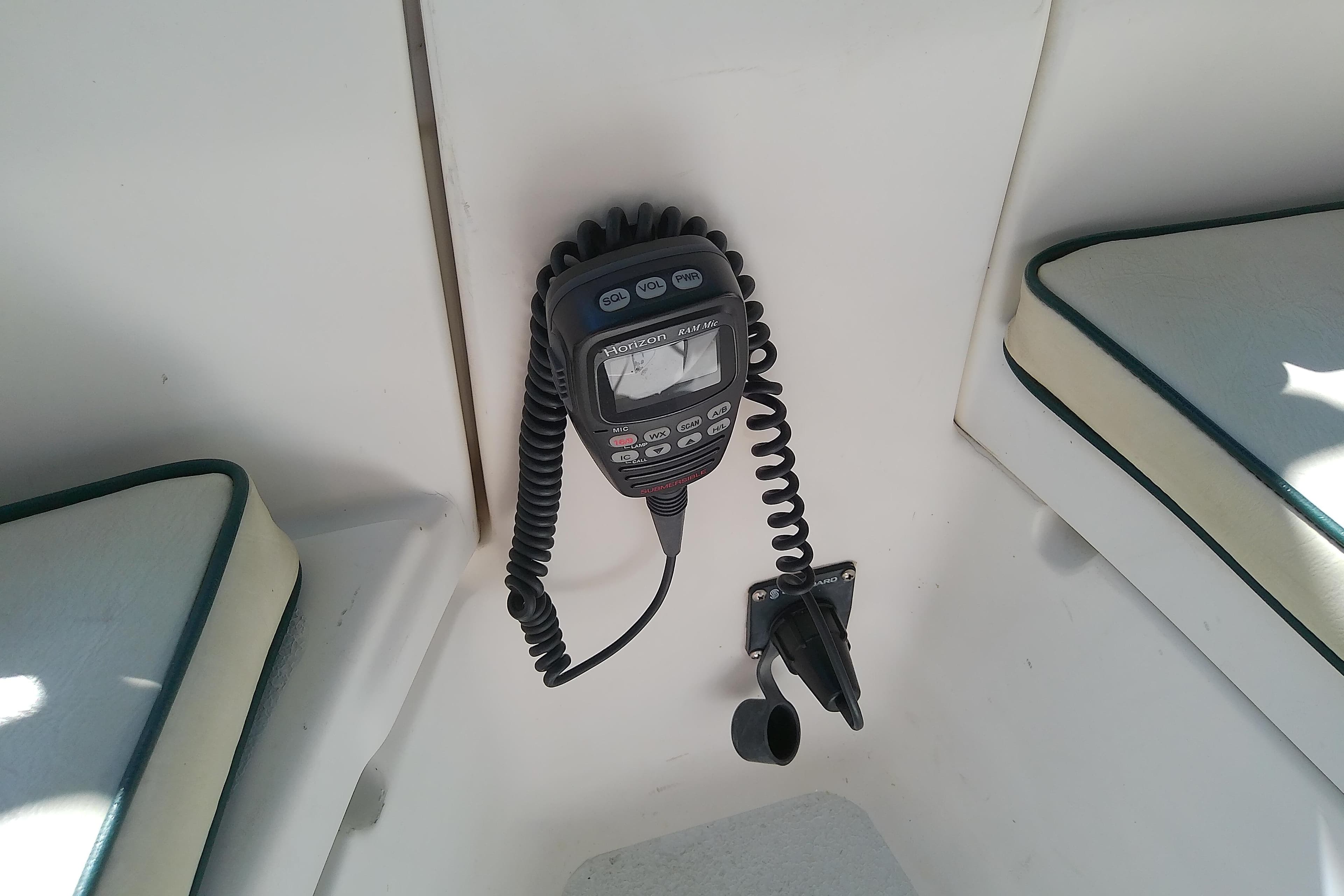 VHF radio installed on a 1991 Hunter 30 sailboat, with cushioned seating nearby.