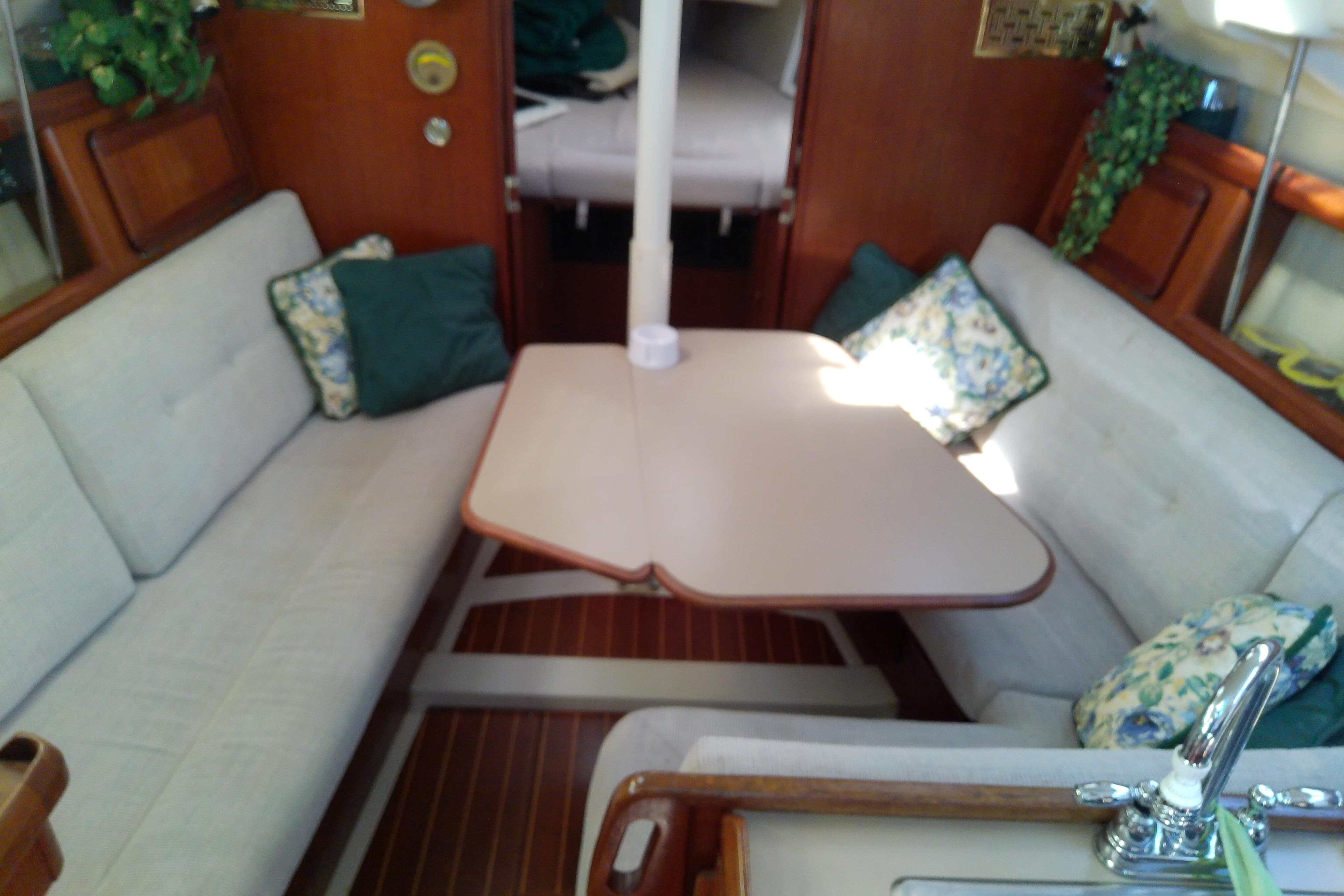 Interior of a 1991 Hunter 30 sailboat with cozy seating and table.