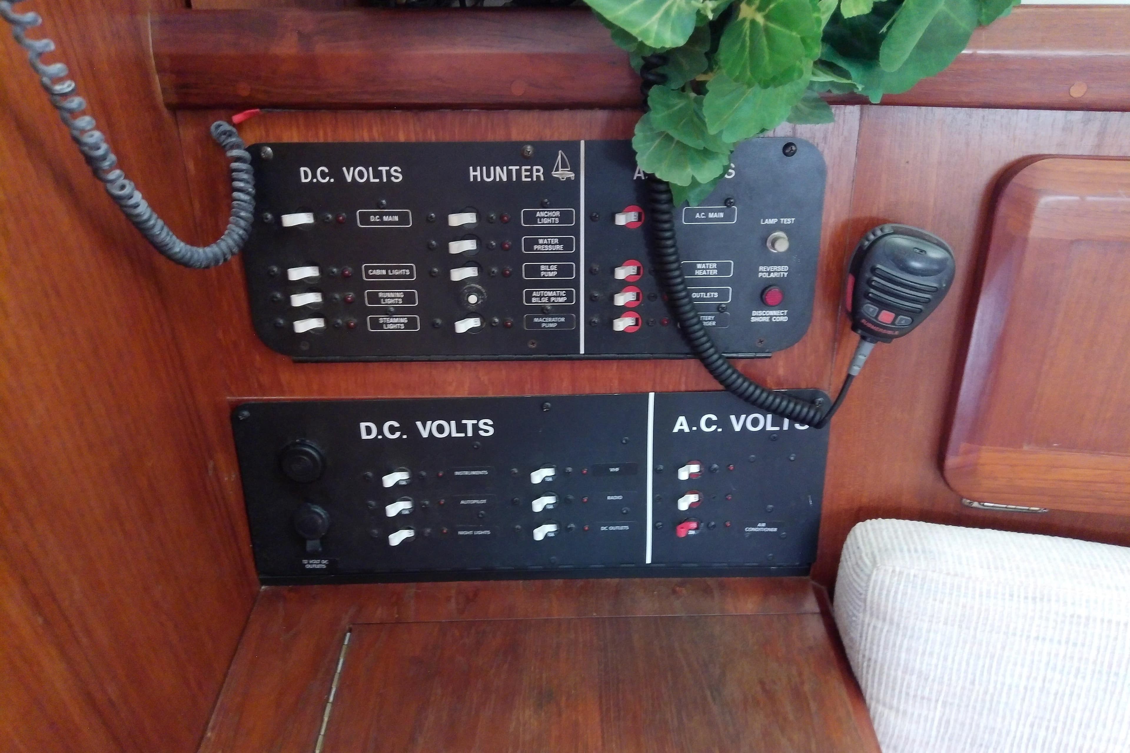 Electrical control panel on a 1991 Hunter 30 sailboat, featuring DC and AC volt switches.