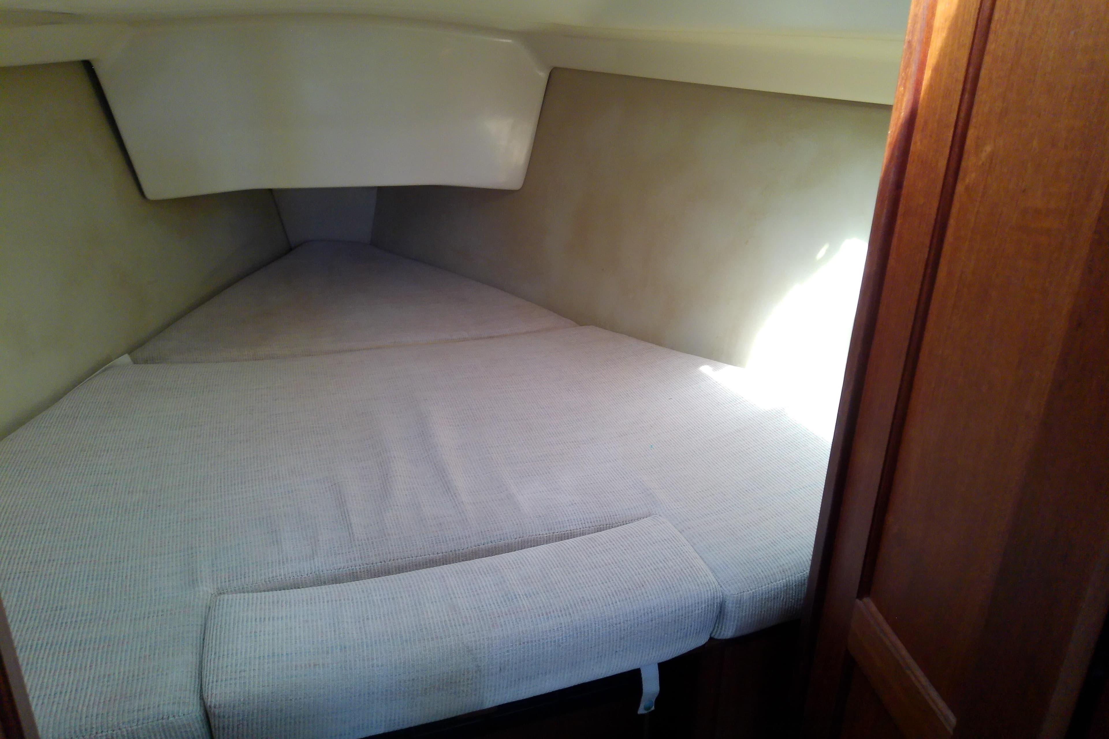 Interior cabin of a 1991 Hunter 30 sailboat with a cozy sleeping area.