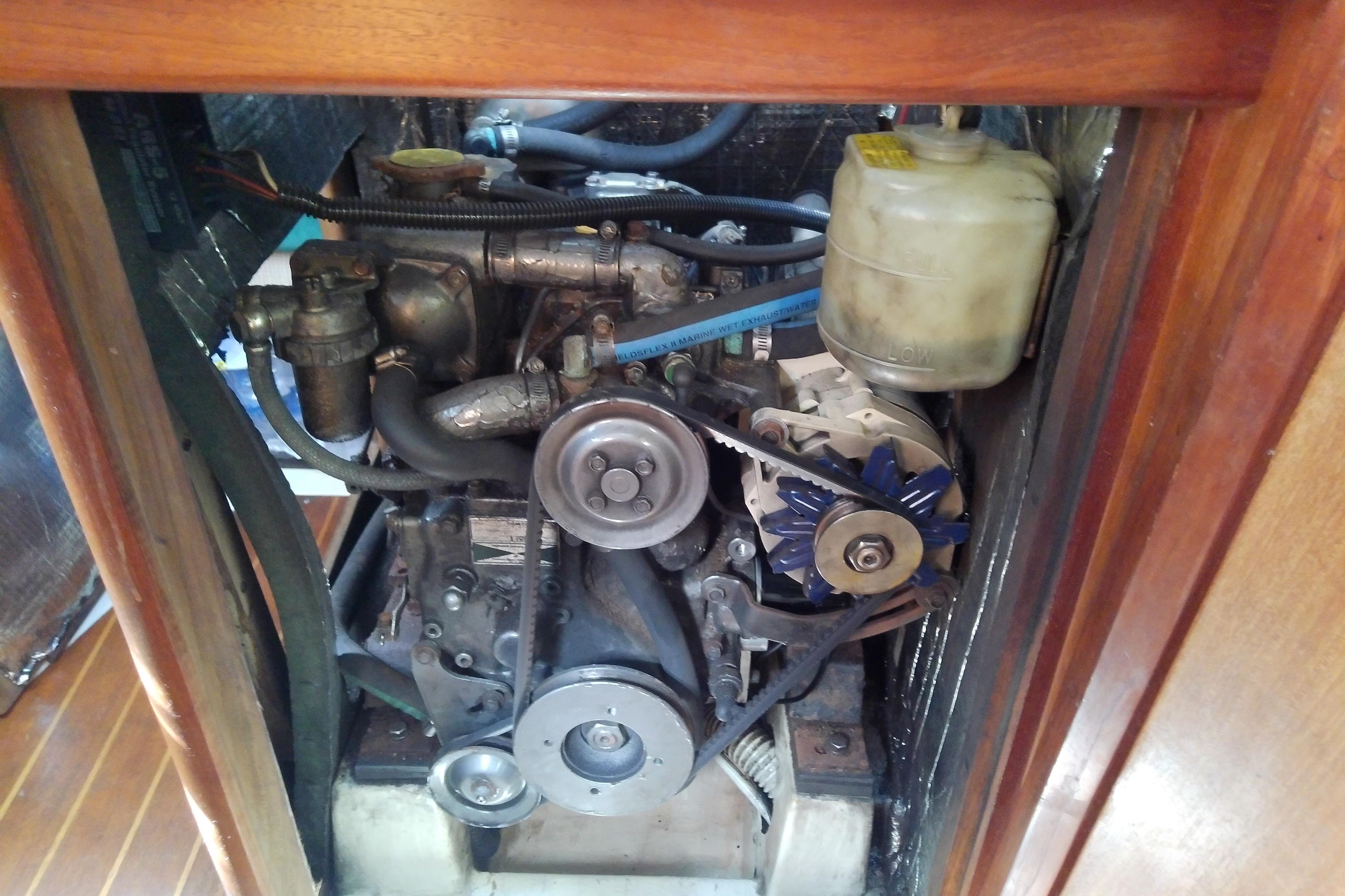 Engine compartment of a 1991 Hunter 30 sailboat, showcasing mechanical components.