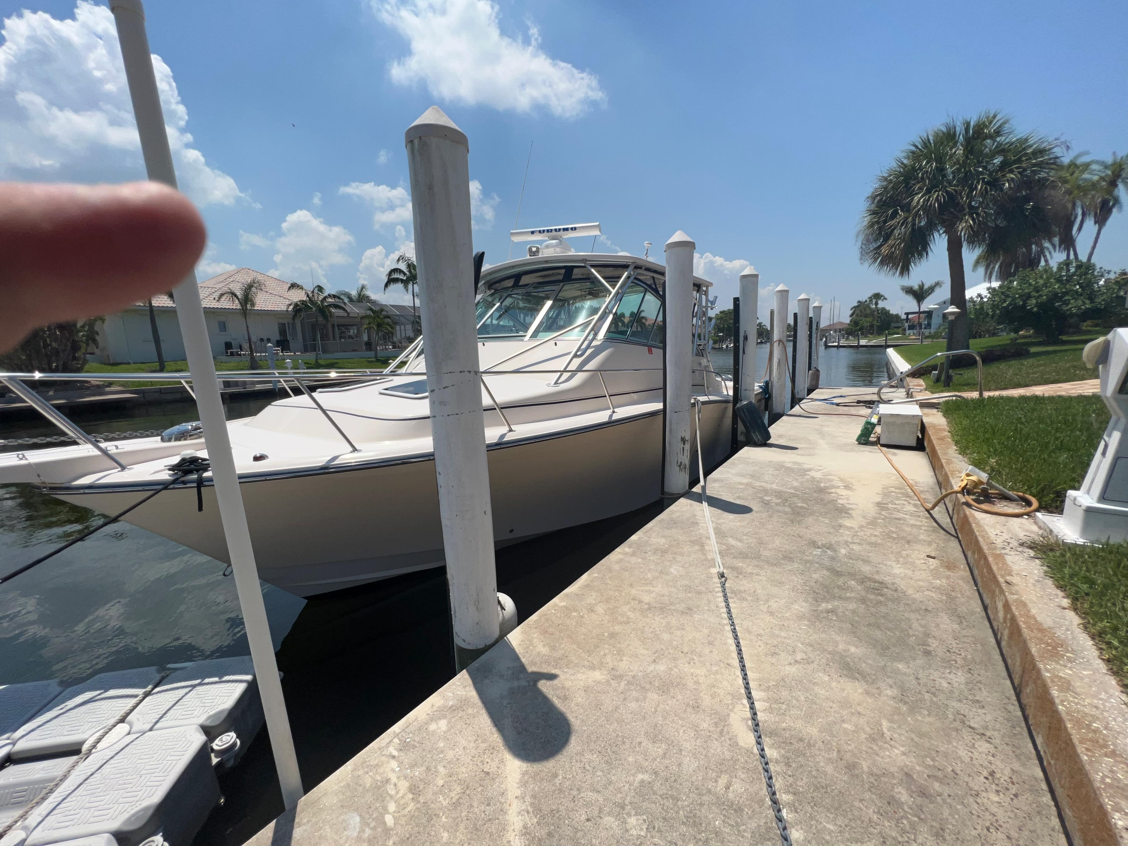2006 Grady-White 360 Express docked under a clear blue sky.
