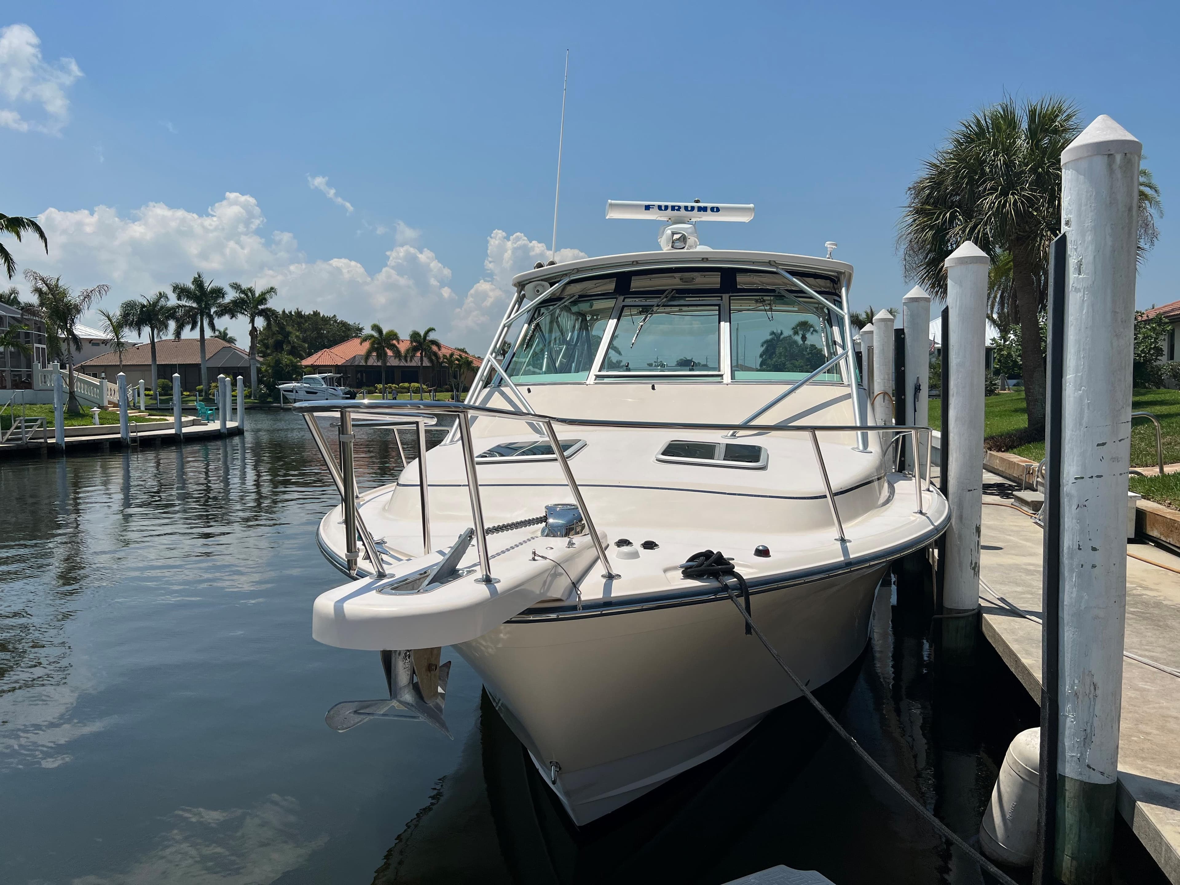 2006 Grady-White 360 Express boat docked in a sunny marina.