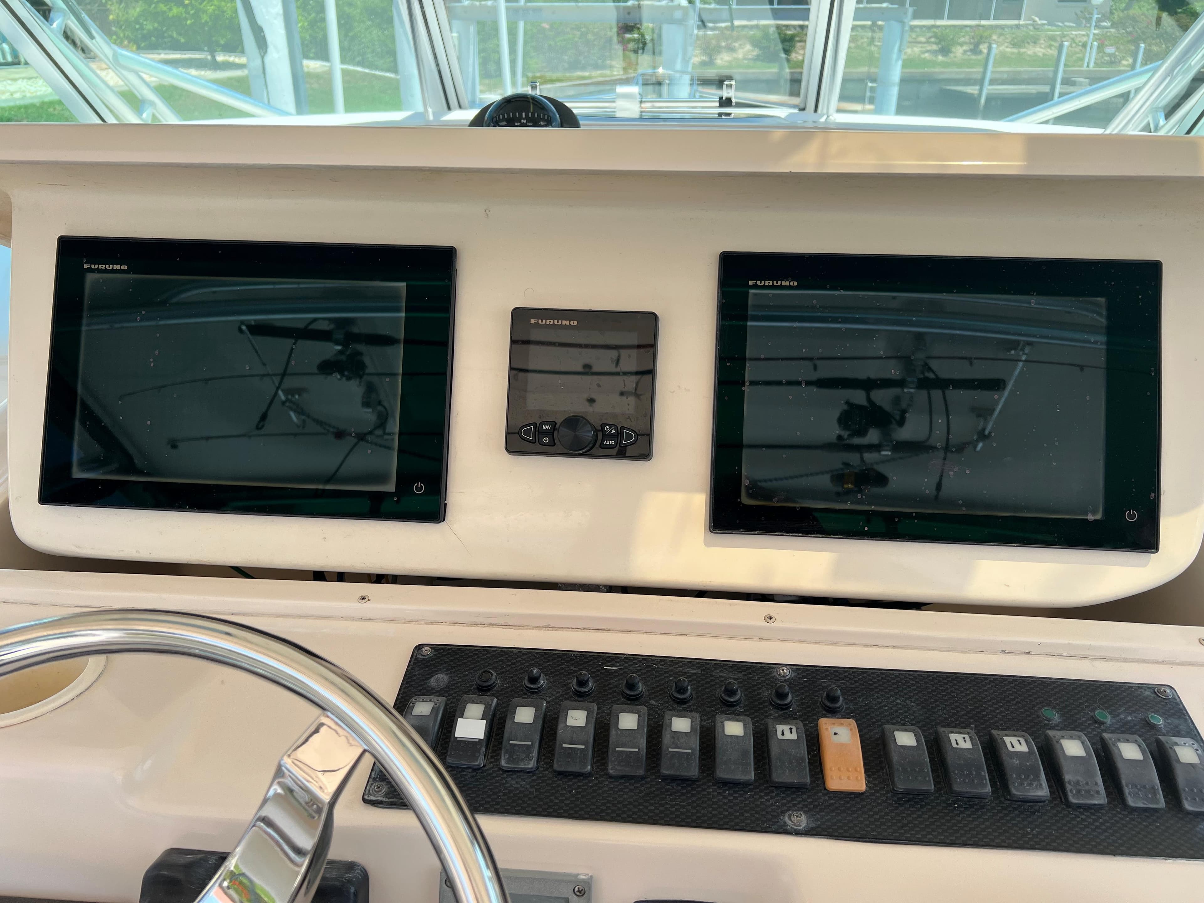 2006 Grady-White 360 Express helm with dual navigation screens and control panel.