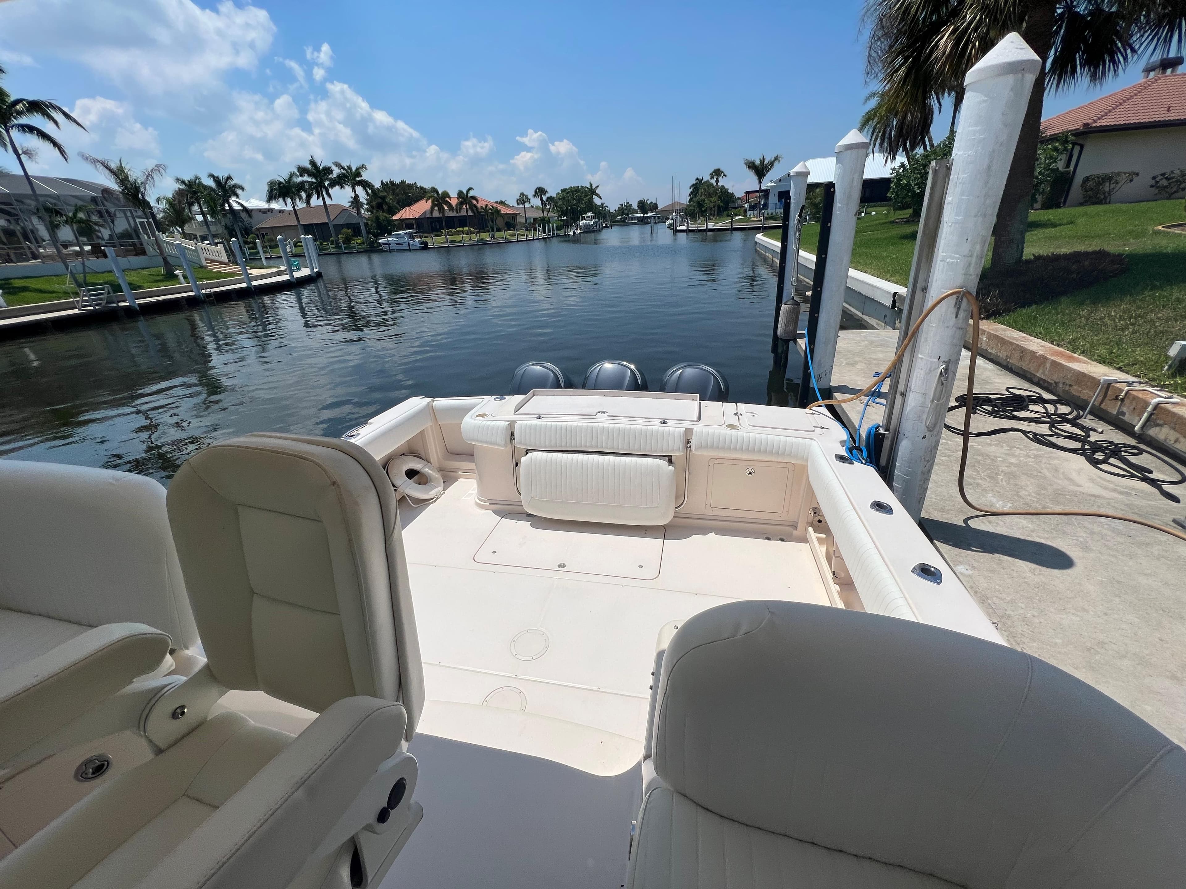 2006 Grady-White 360 Express boat docked by a scenic canal.