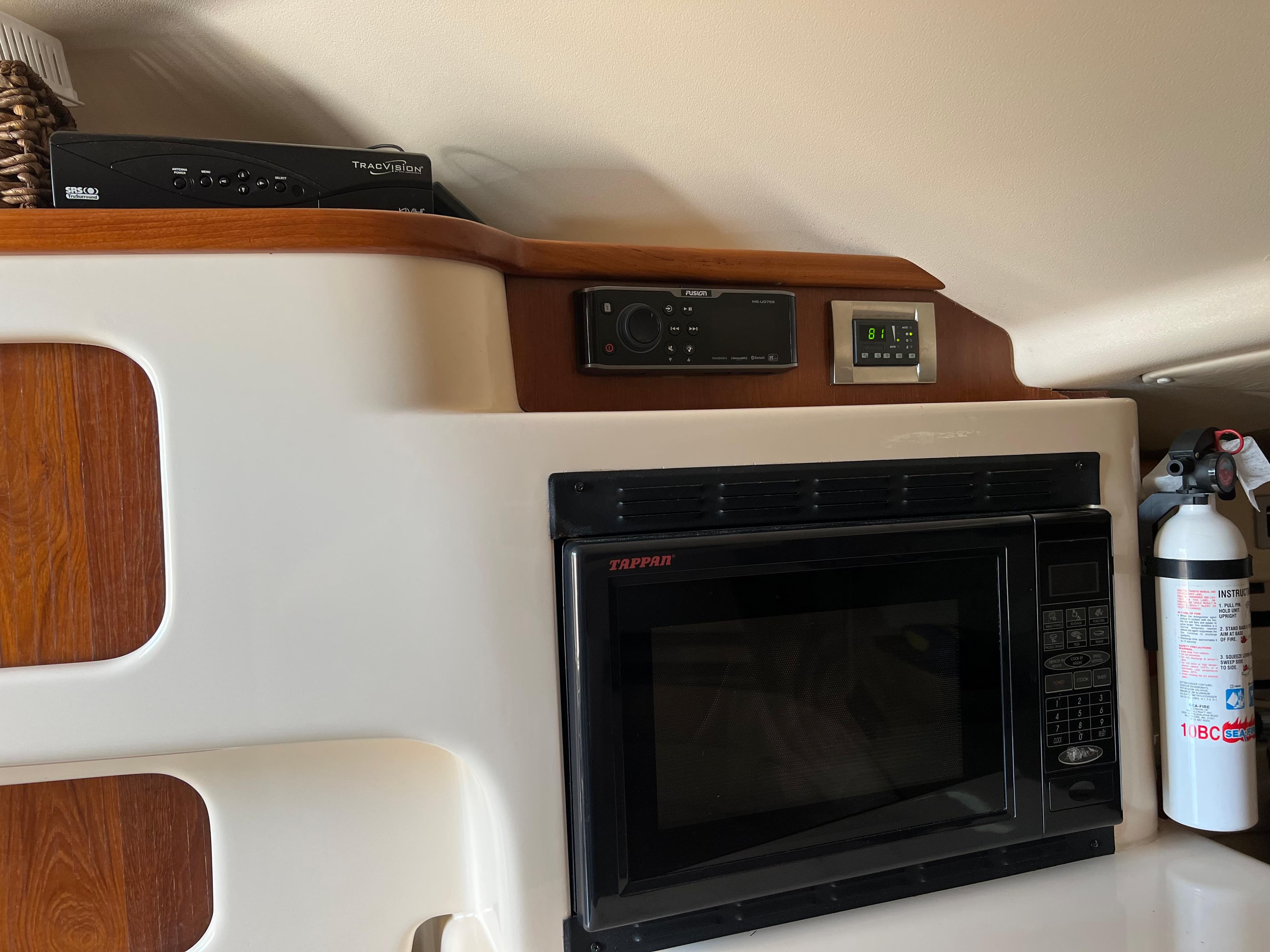 2006 Grady-White 360 Express interior with microwave and fire extinguisher.