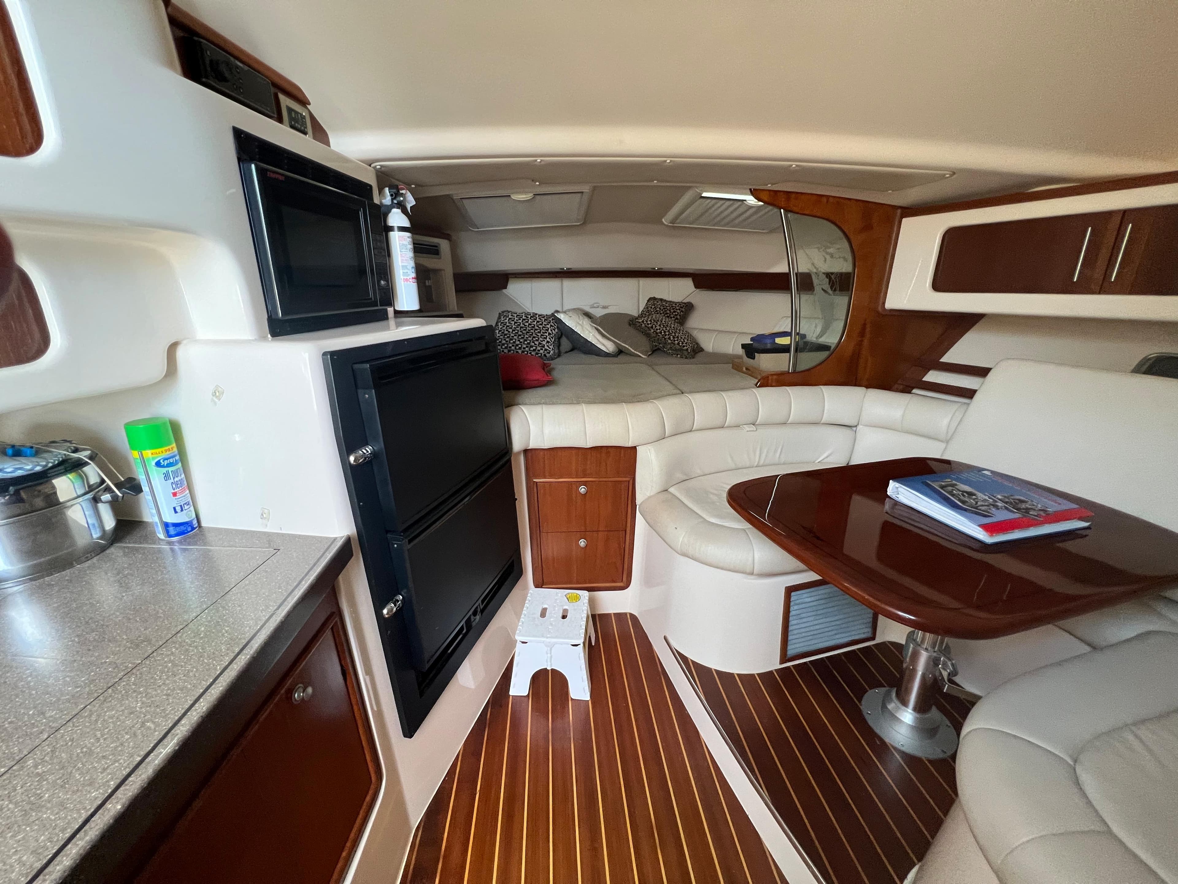 Luxurious 2006 Grady-White 360 Express cabin interior with wood accents and cozy seating.