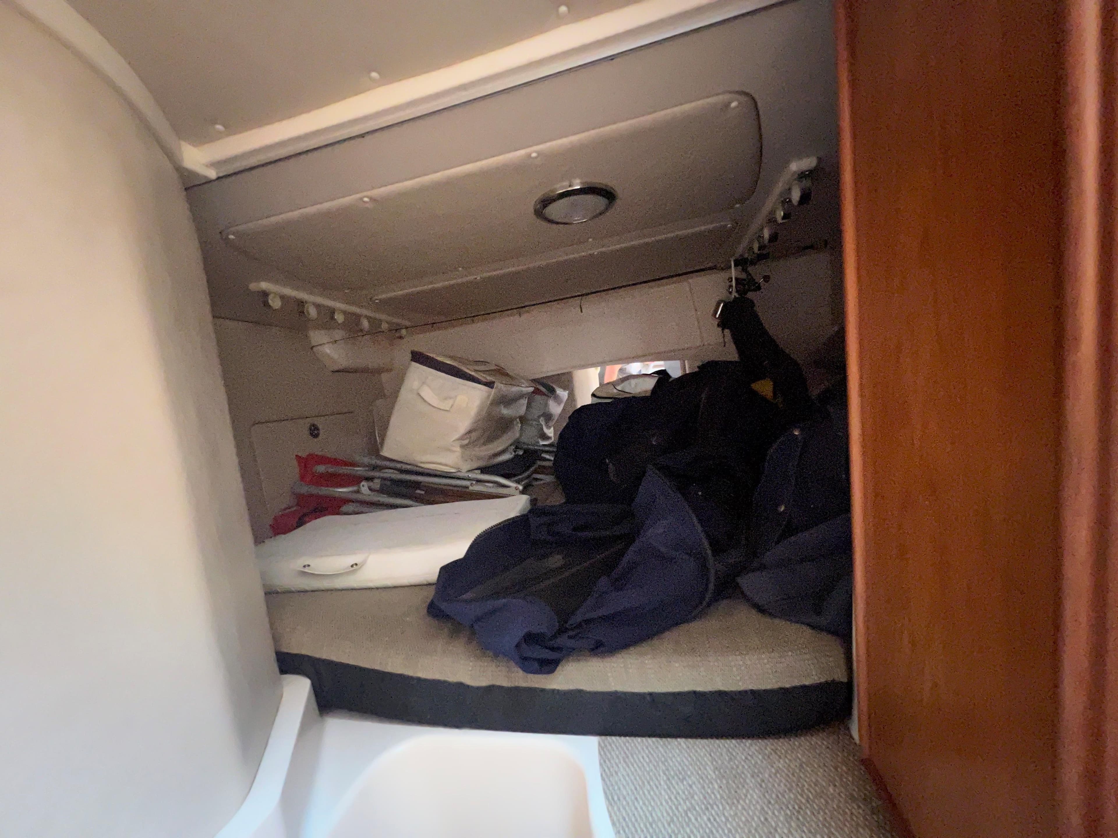 Interior cabin of 2006 Grady-White 360 Express boat with storage items.