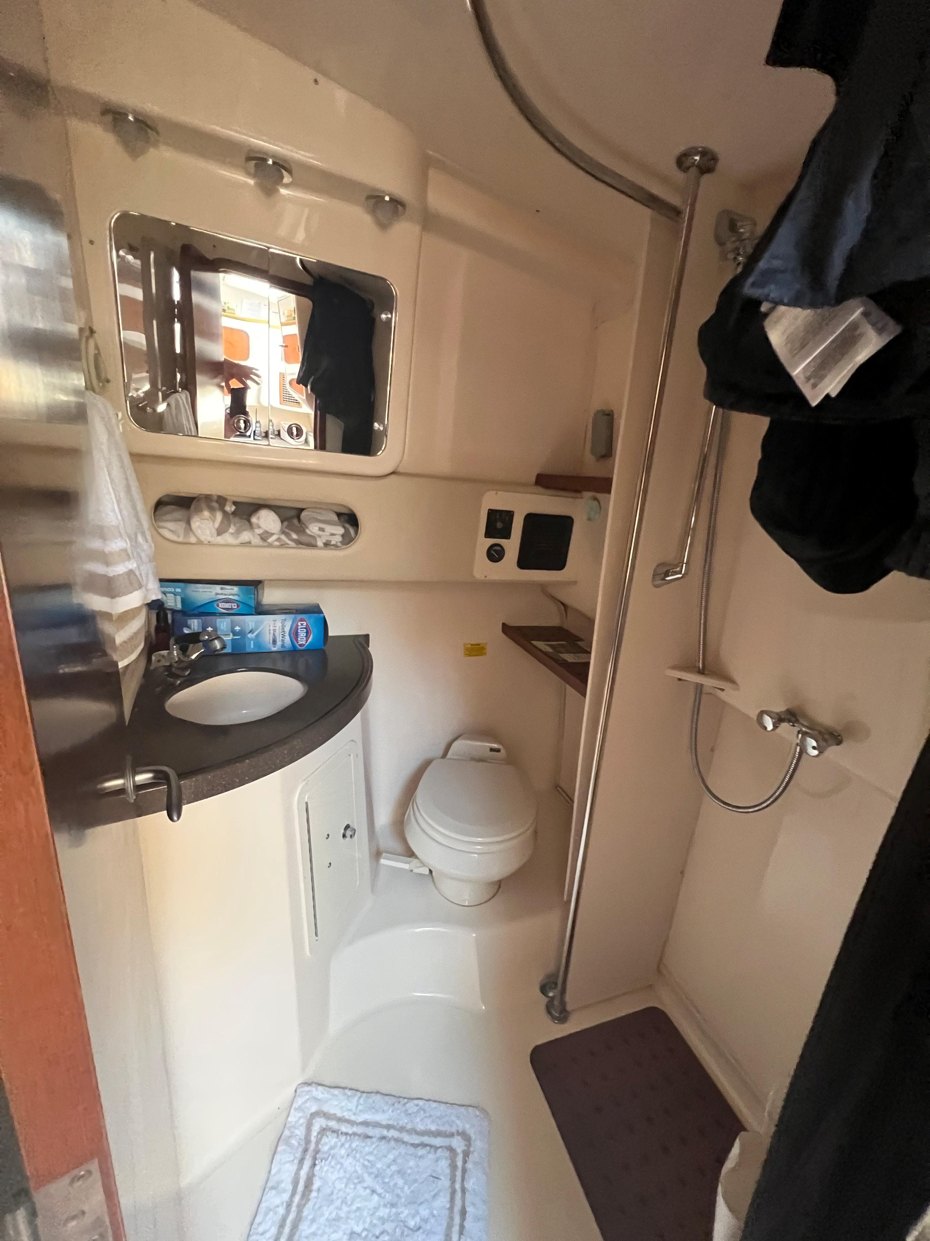 2006 Grady-White 360 Express boat bathroom with shower, sink, and mirror.