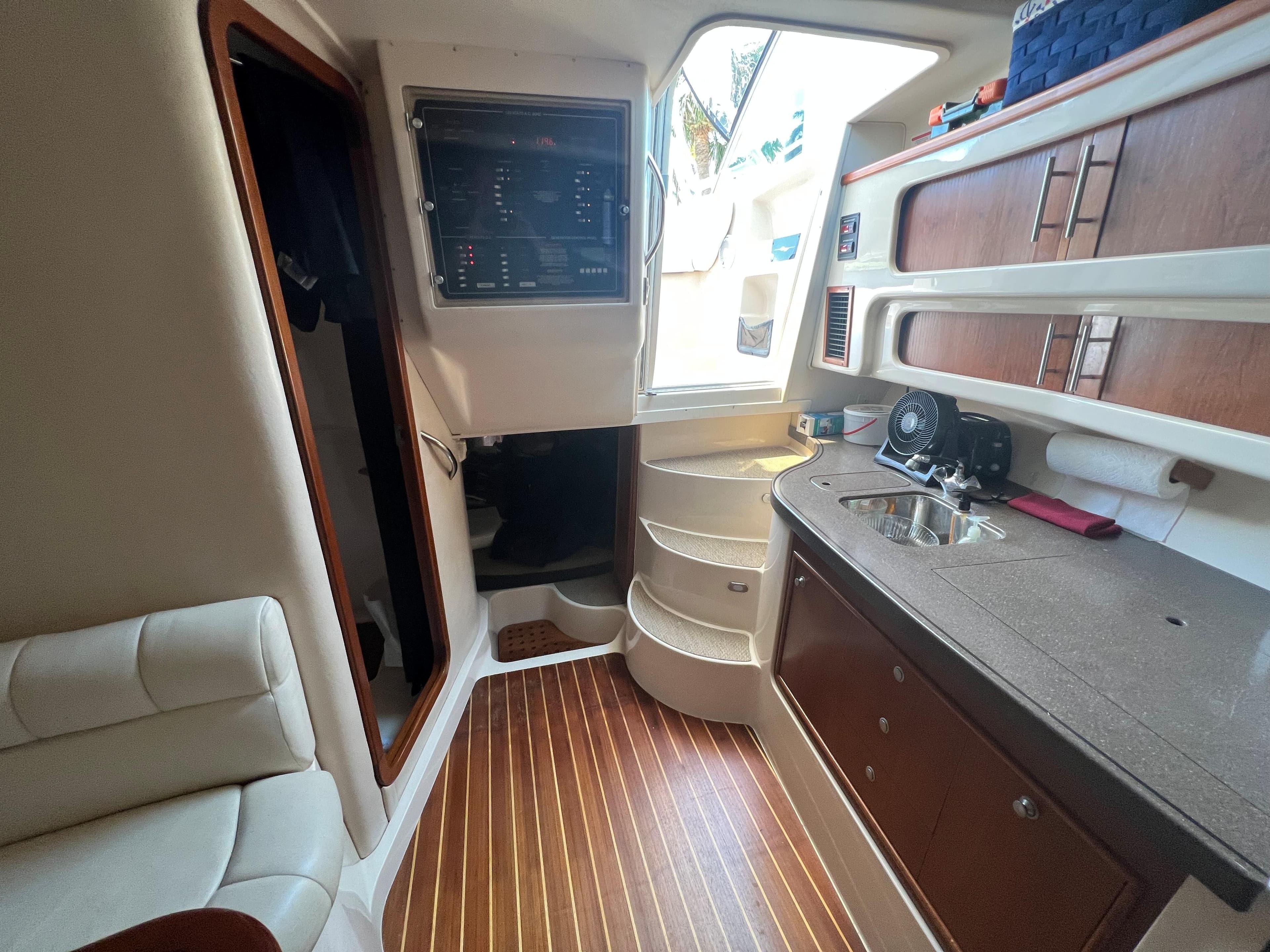 Interior of 2006 Grady-White 360 Express boat with wood flooring and compact kitchen area.
