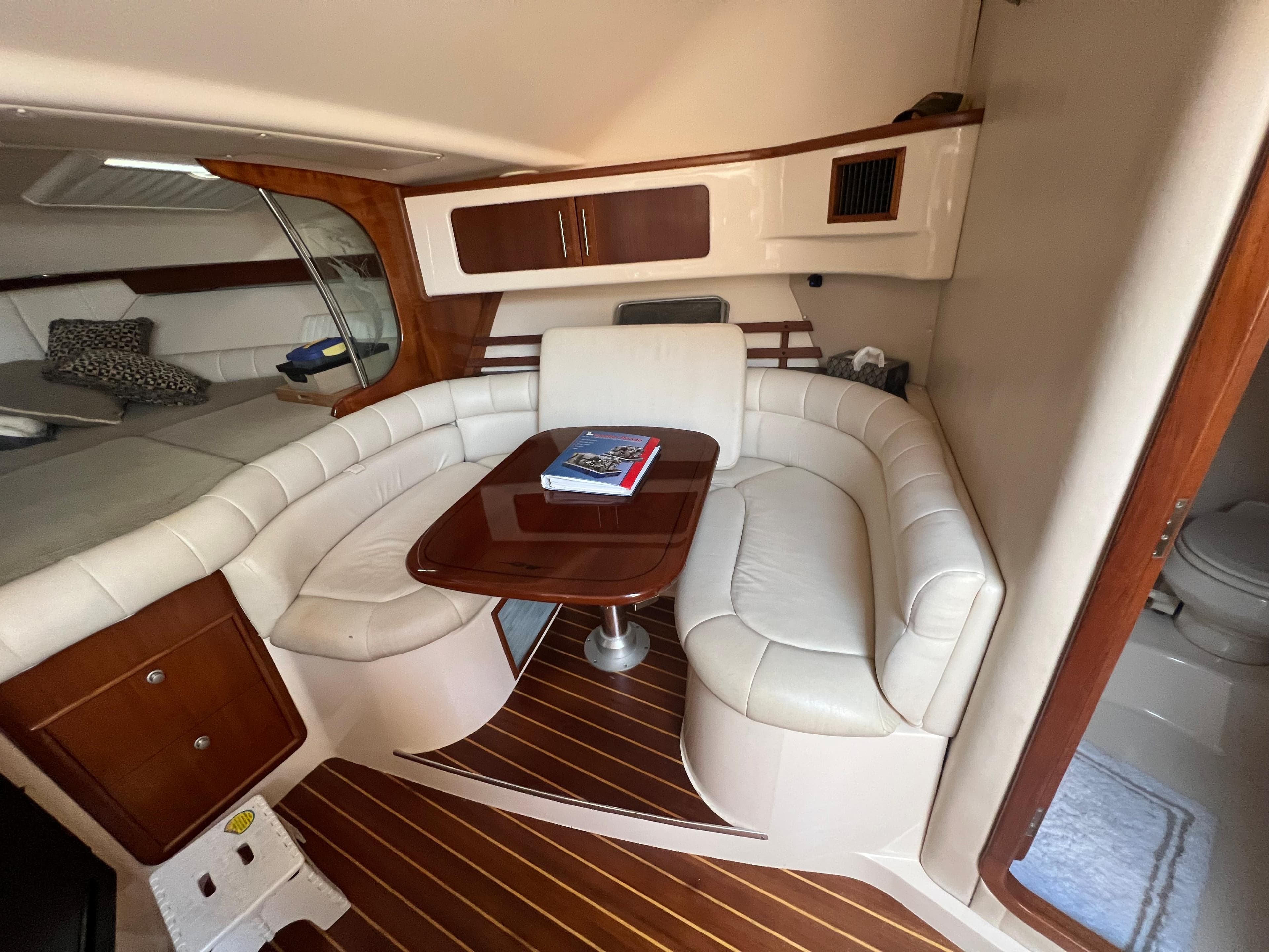 2006 Grady-White 360 Express yacht interior with white leather seating and wooden accents.