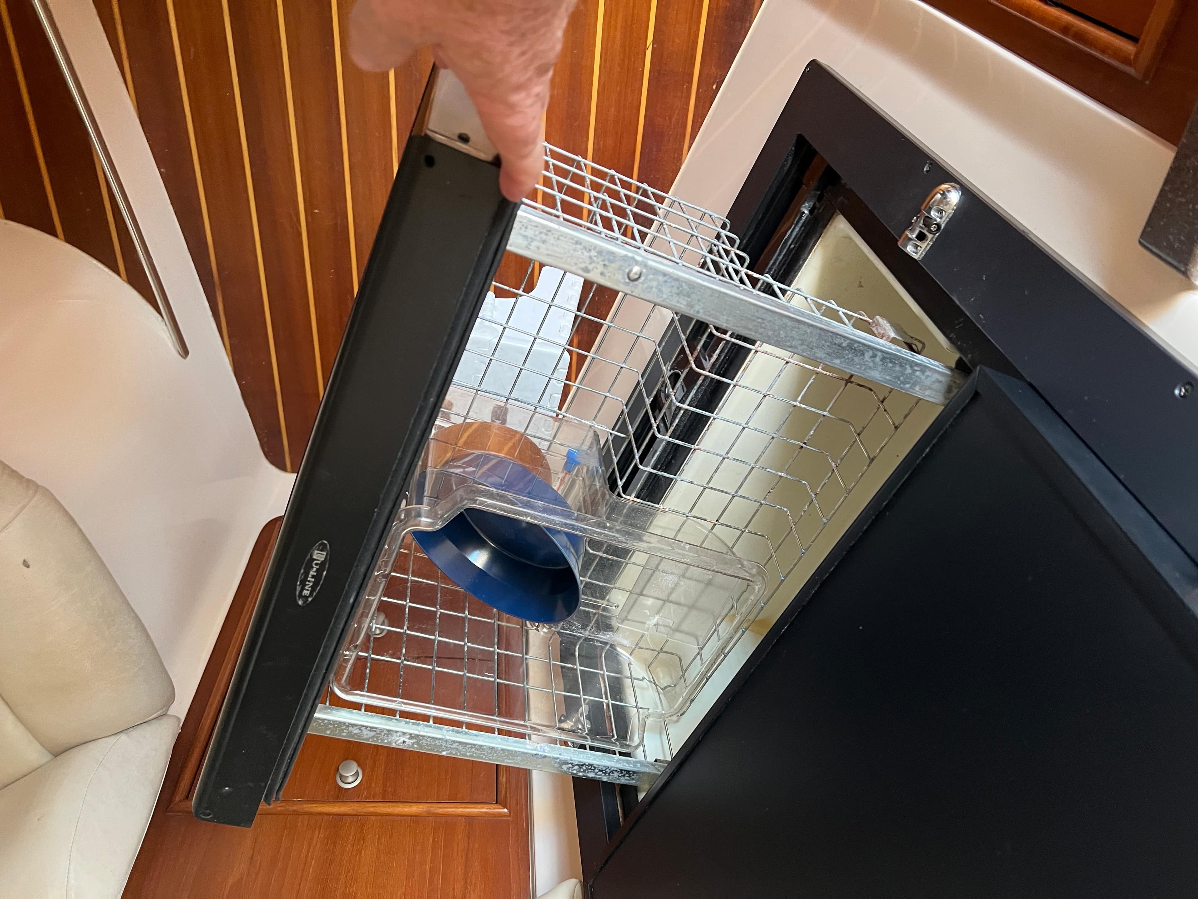 Pull-out wire basket in 2006 Grady-White 360 Express boat interior.